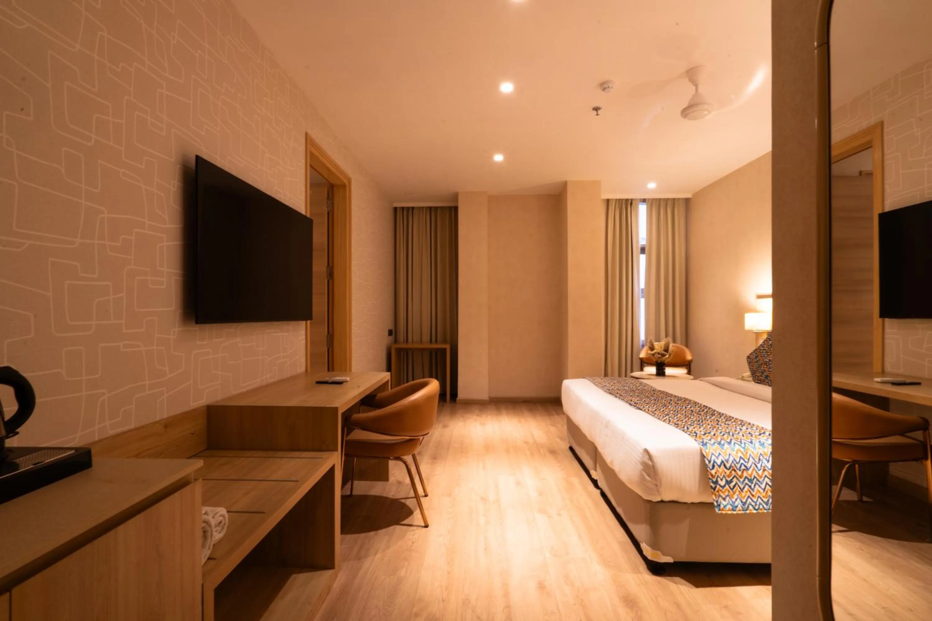 Seating area, Bed in Hotel Bluestone Prime Nehru Place by The Cosy hotels