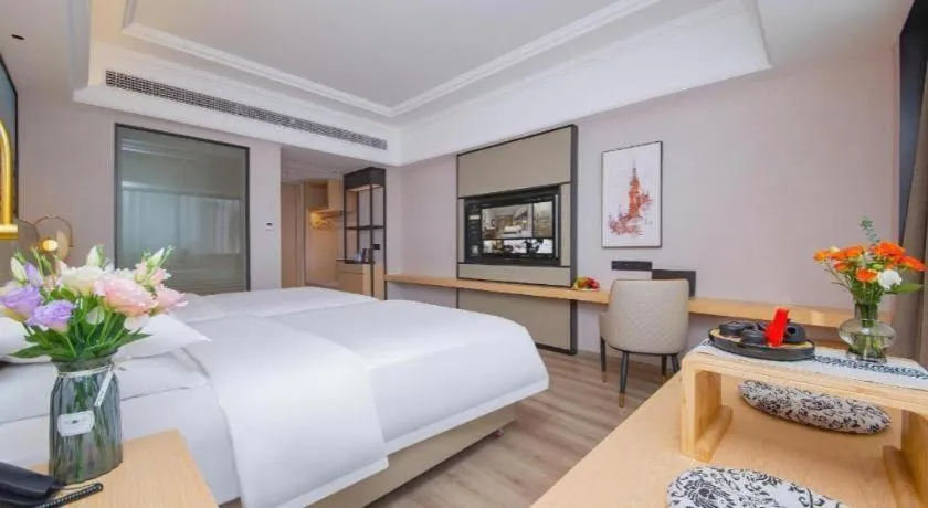 Bed in Vienna International Hotel Wuhan Huanghelou Pengliuyang Metro Station