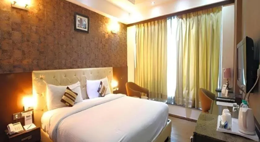 Bed in Hotel Signature Grand