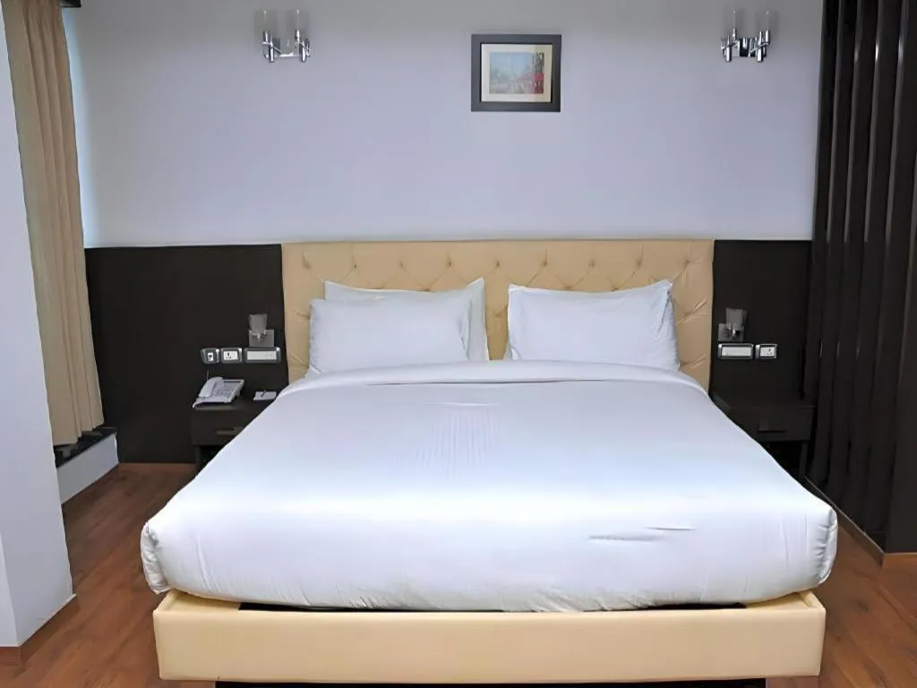 Bed in Hotel Signature Grand