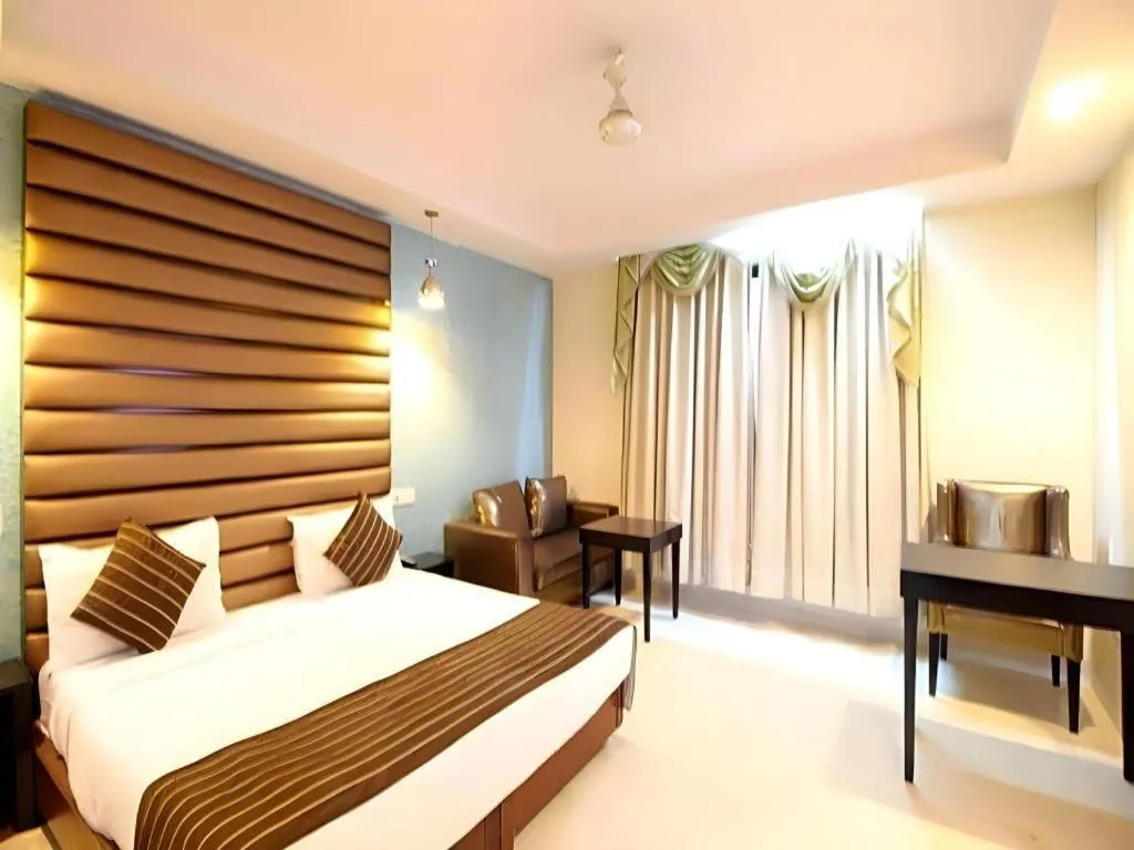 Bed in Hotel Signature Grand