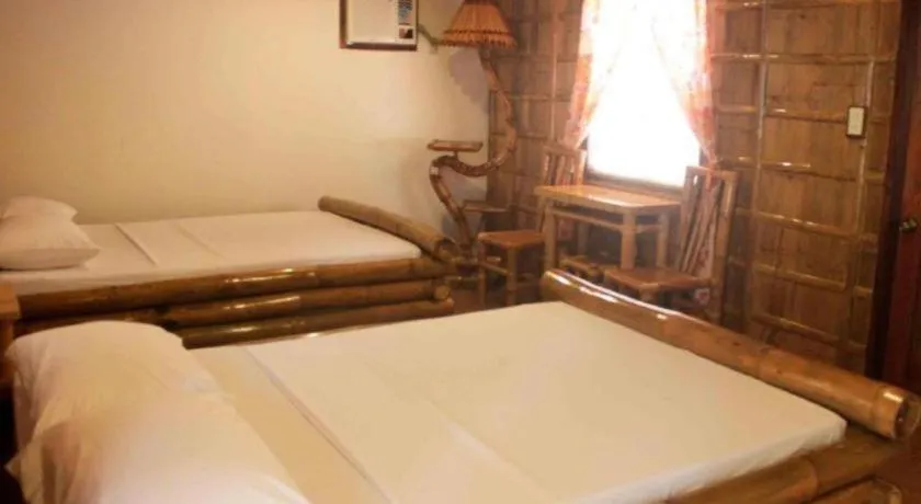 Bed in Nataasan Beach Resort and Dive Center