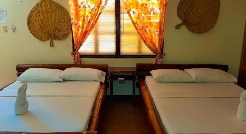 Bed in Nataasan Beach Resort and Dive Center