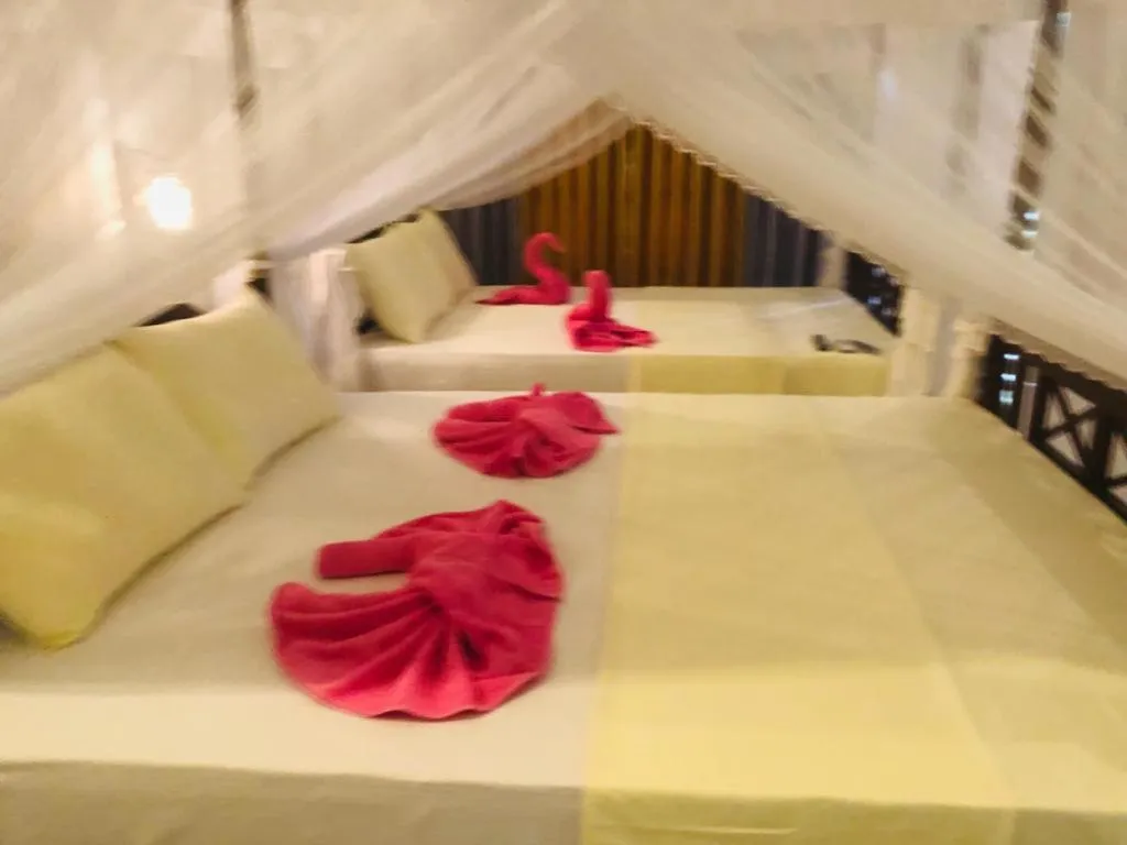 Bed in Coral Palm Villa and Apartment