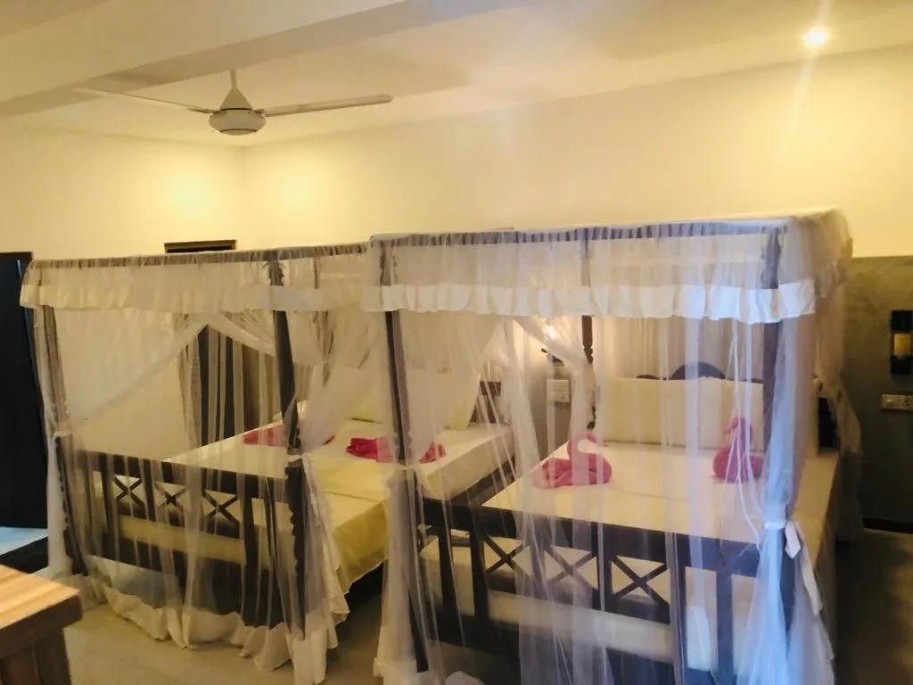 Bed in Coral Palm Villa and Apartment