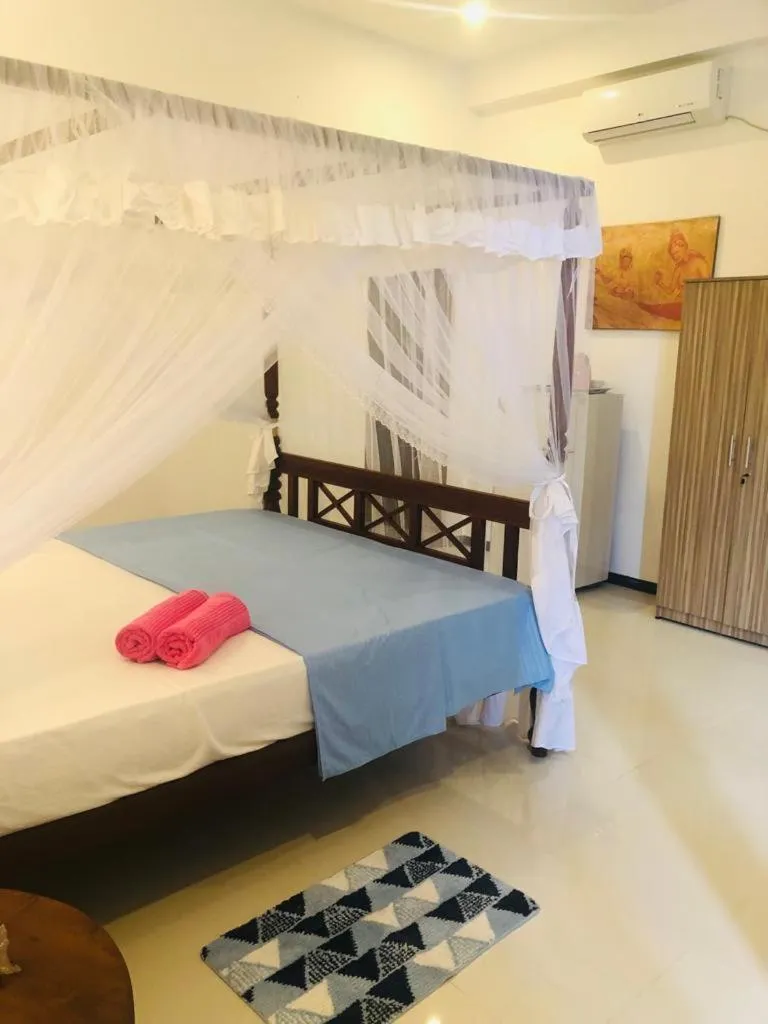 Bed in Coral Palm Villa and Apartment