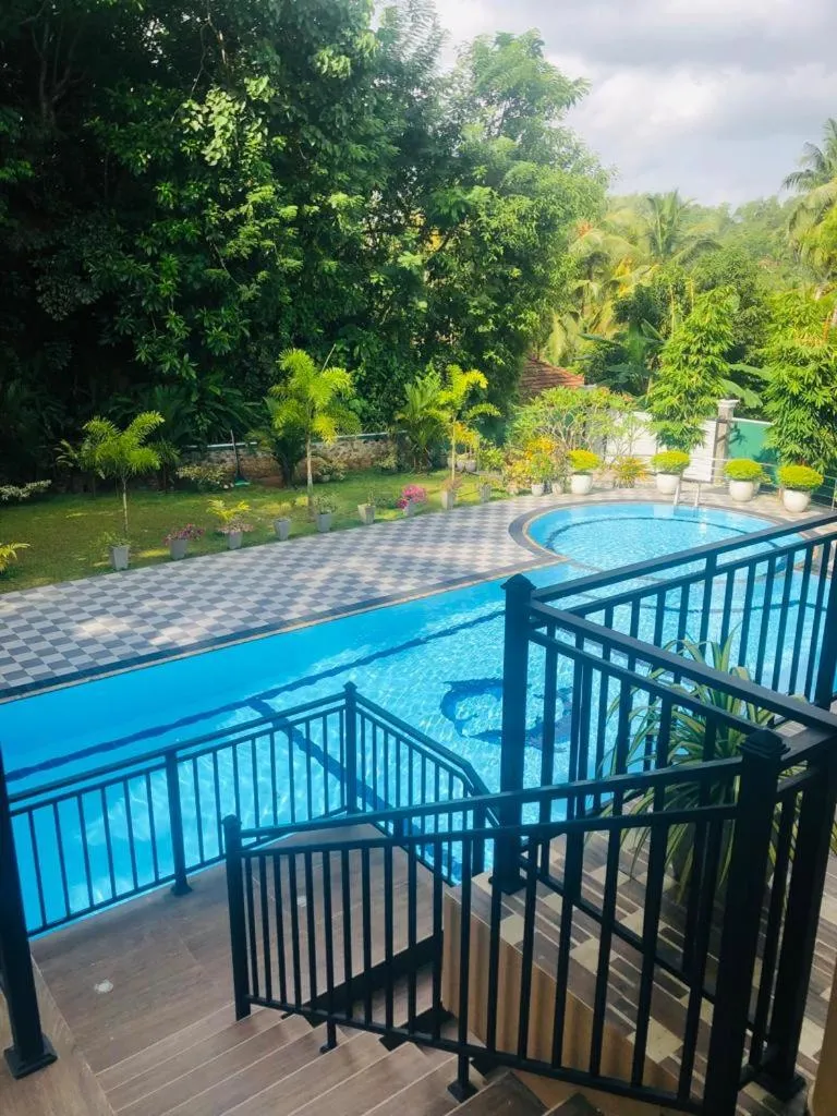 Swimming pool in Coral Palm Villa and Apartment