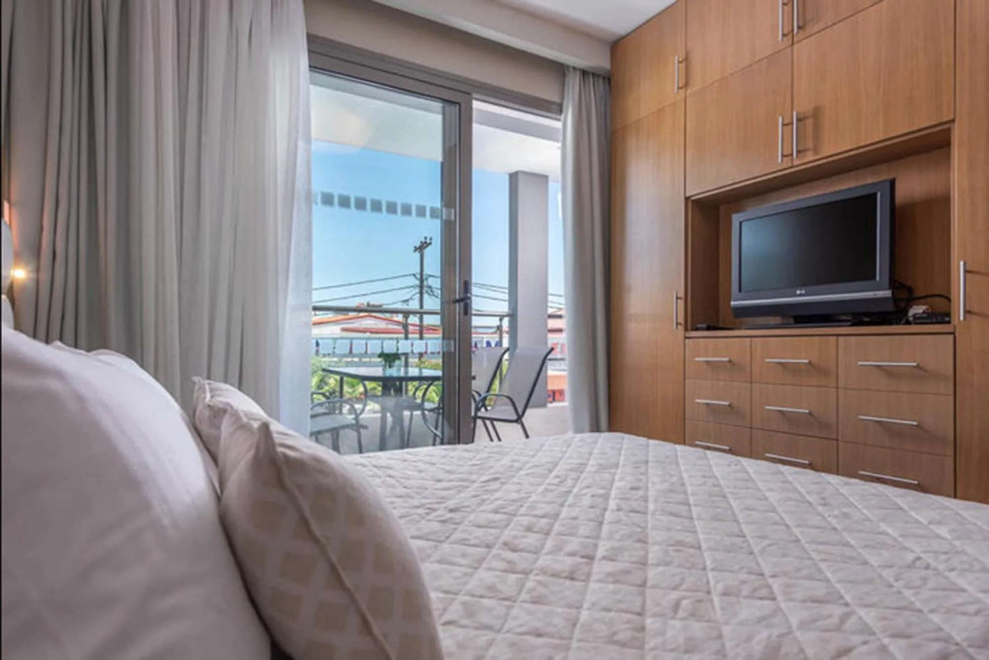 Bed in Dionysos Hotel & Suites