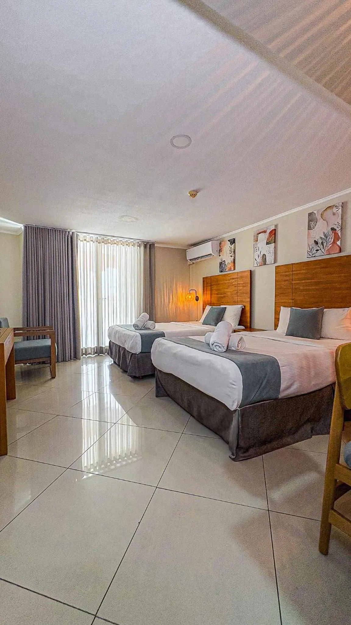 Bed in Majestic City Suites & Beach Hotel