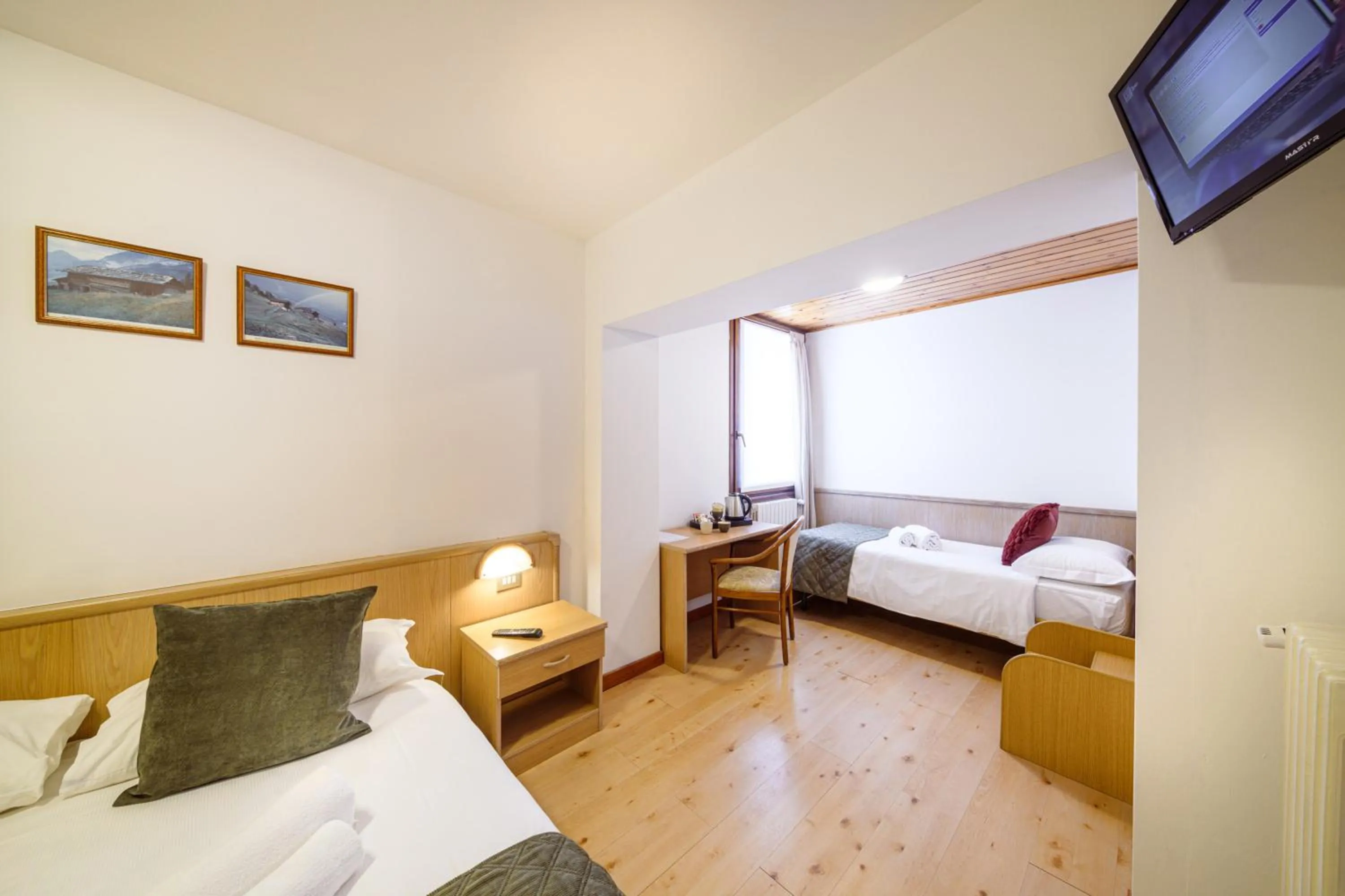 Bed in Hotel Ambassador Bormio