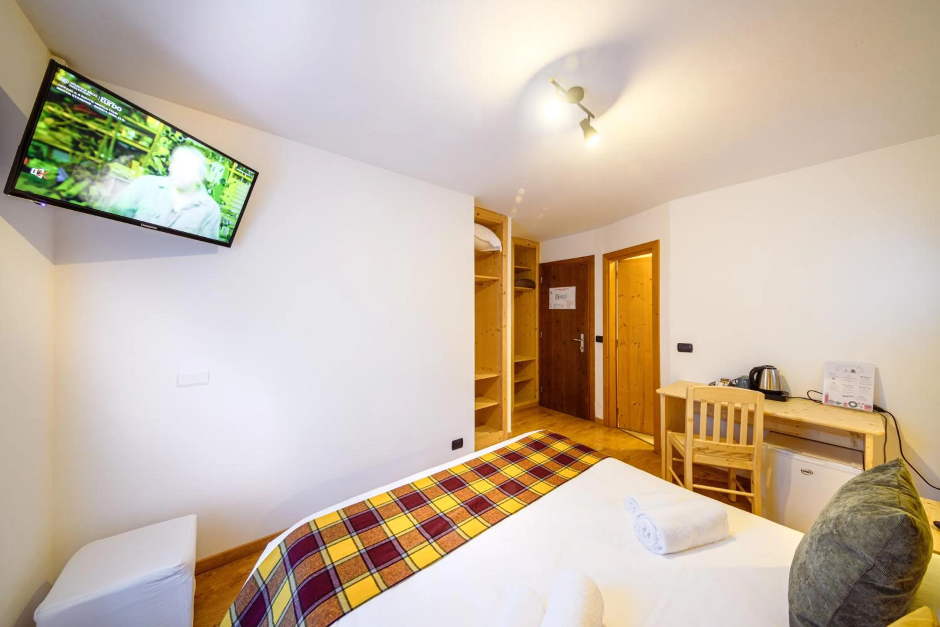 Bed in Hotel Ambassador Bormio