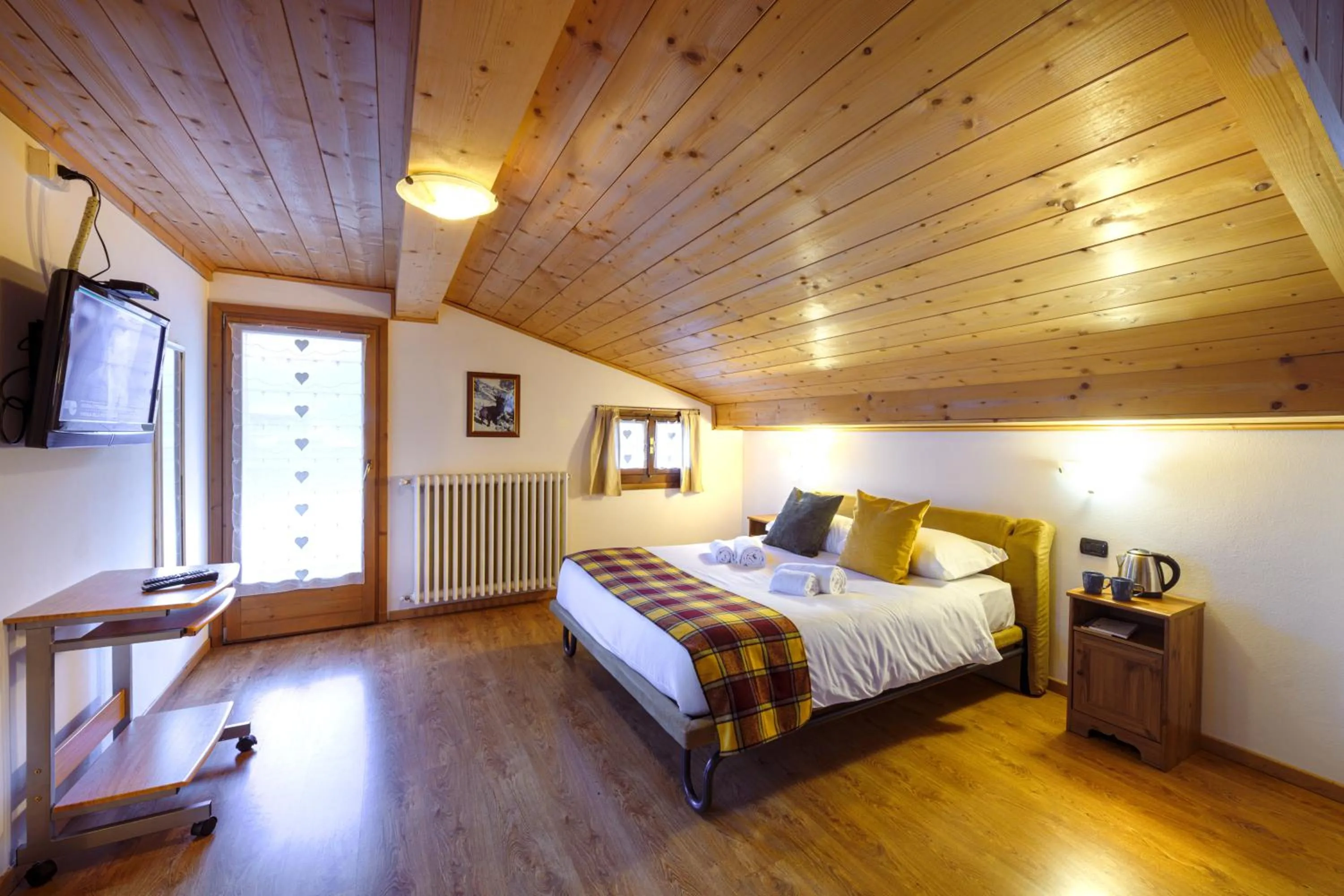 Bed in Hotel Ambassador Bormio
