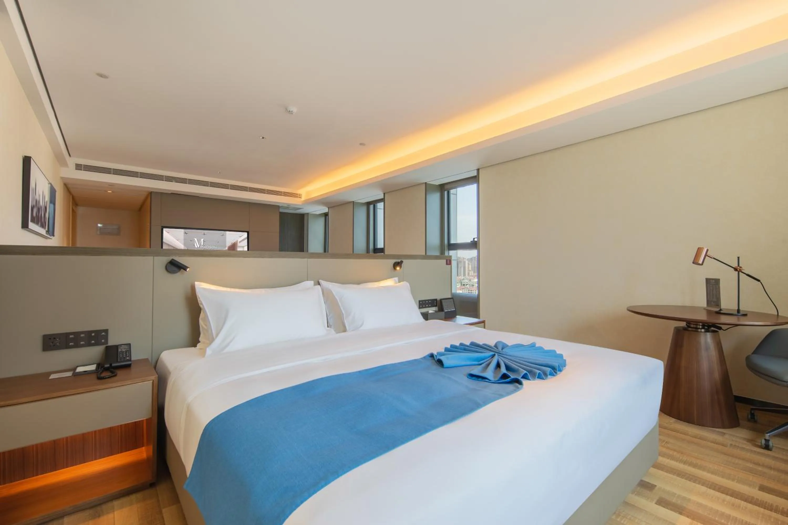 Bed in Madison Hotel Qingdao West Coast City Balcony