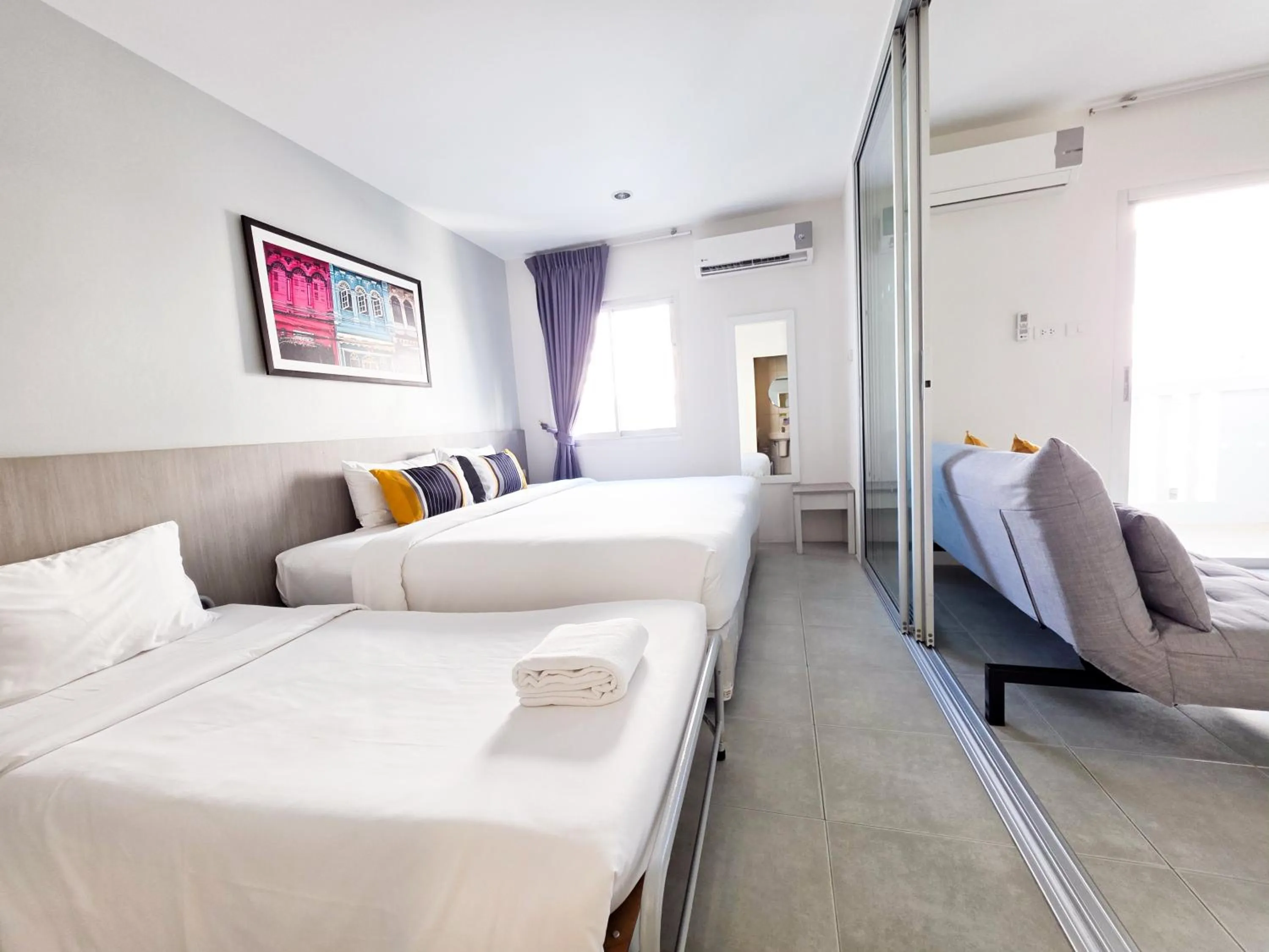 Bed in Recenta Suite Phuket Suanluang