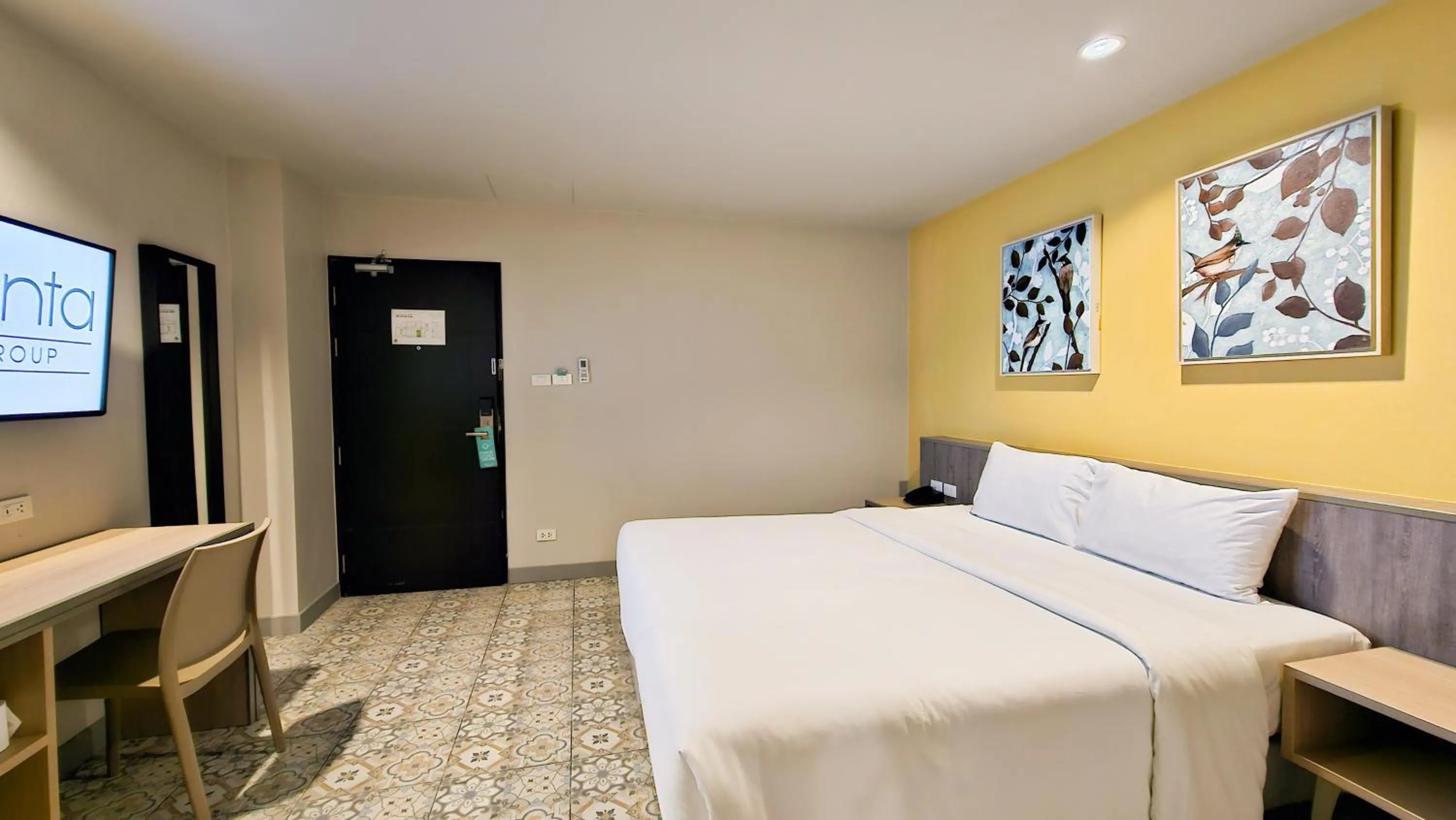 Bed in Recenta Suite Phuket Suanluang