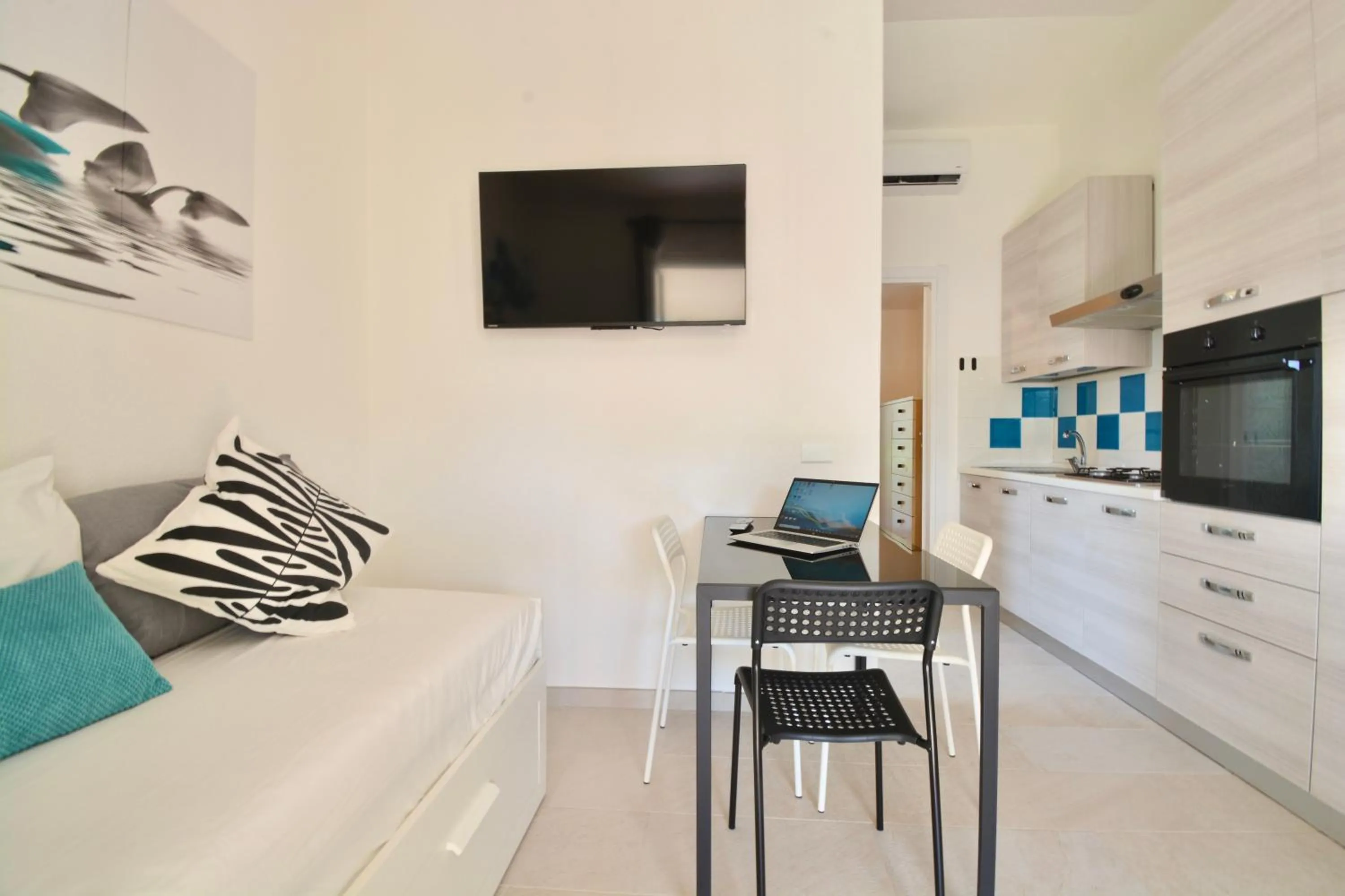 Kitchen or kitchenette in ISA - Residence in Costa Rei just 450 meters from the beach, apartments with air conditioning and outdoor private area