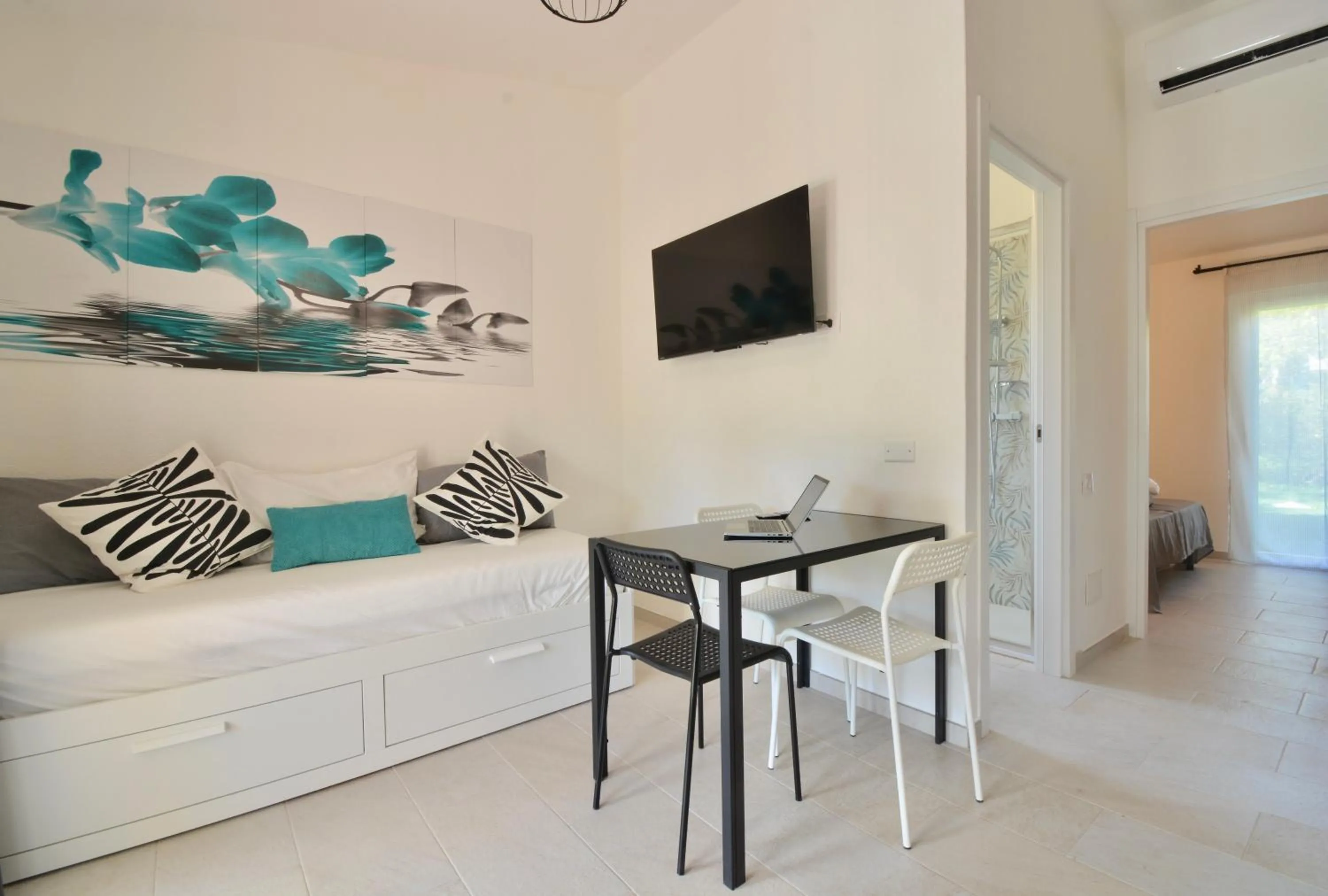 Living room in ISA - Residence in Costa Rei just 450 meters from the beach, apartments with air conditioning and outdoor private area