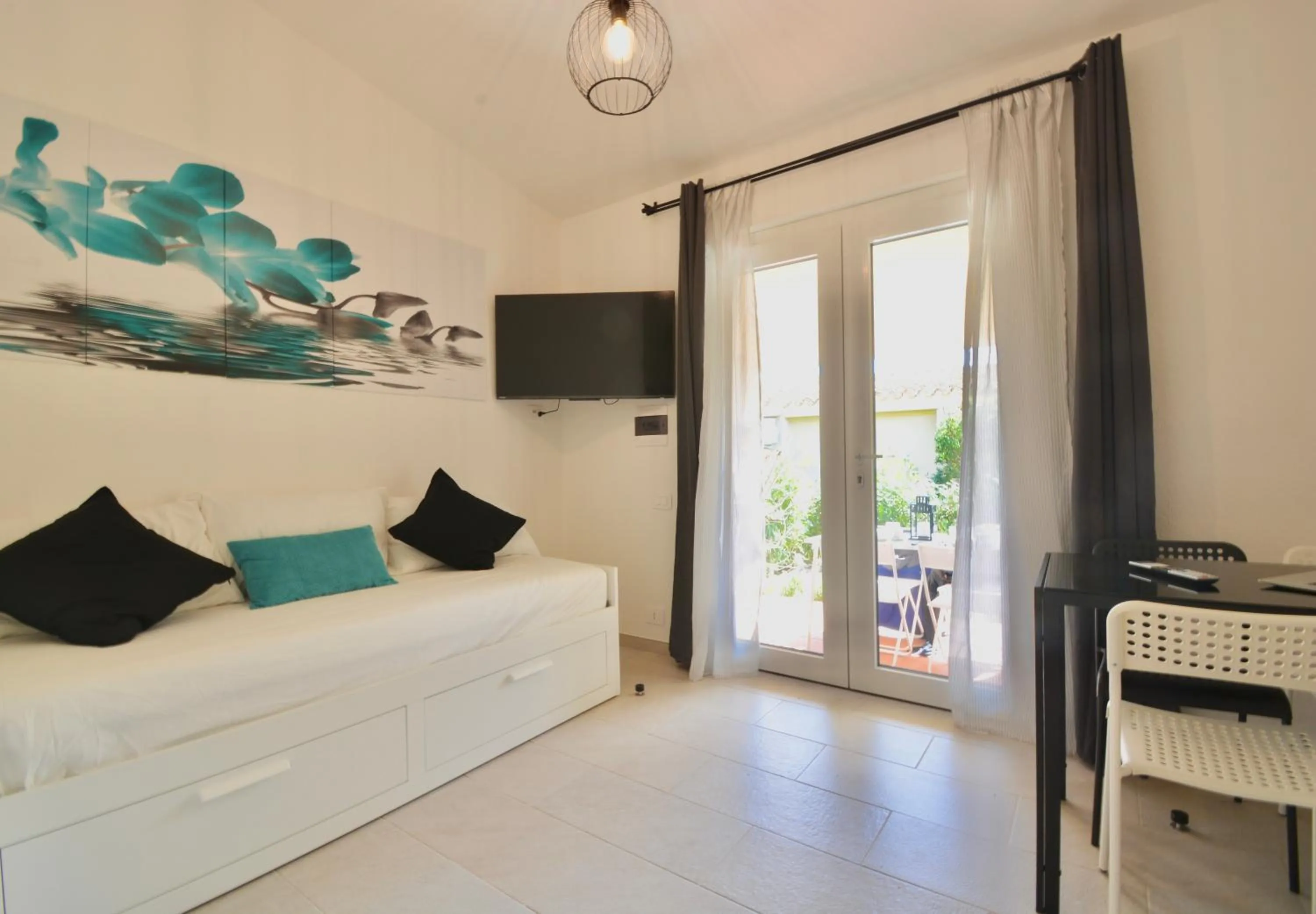 Living room, Bed in ISA - Residence in Costa Rei just 450 meters from the beach, apartments with air conditioning and outdoor private area