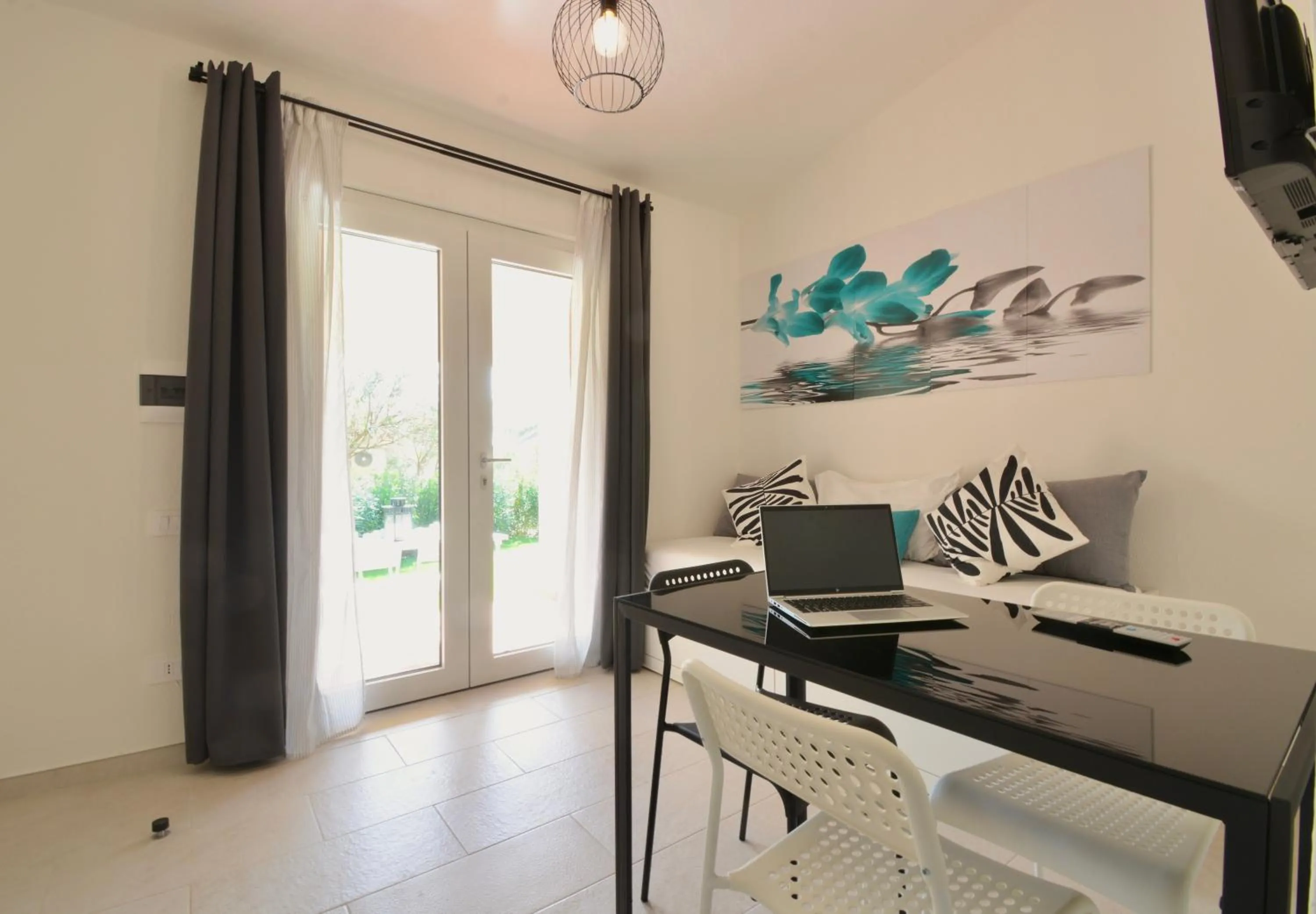 Living room in ISA - Residence in Costa Rei just 450 meters from the beach, apartments with air conditioning and outdoor private area