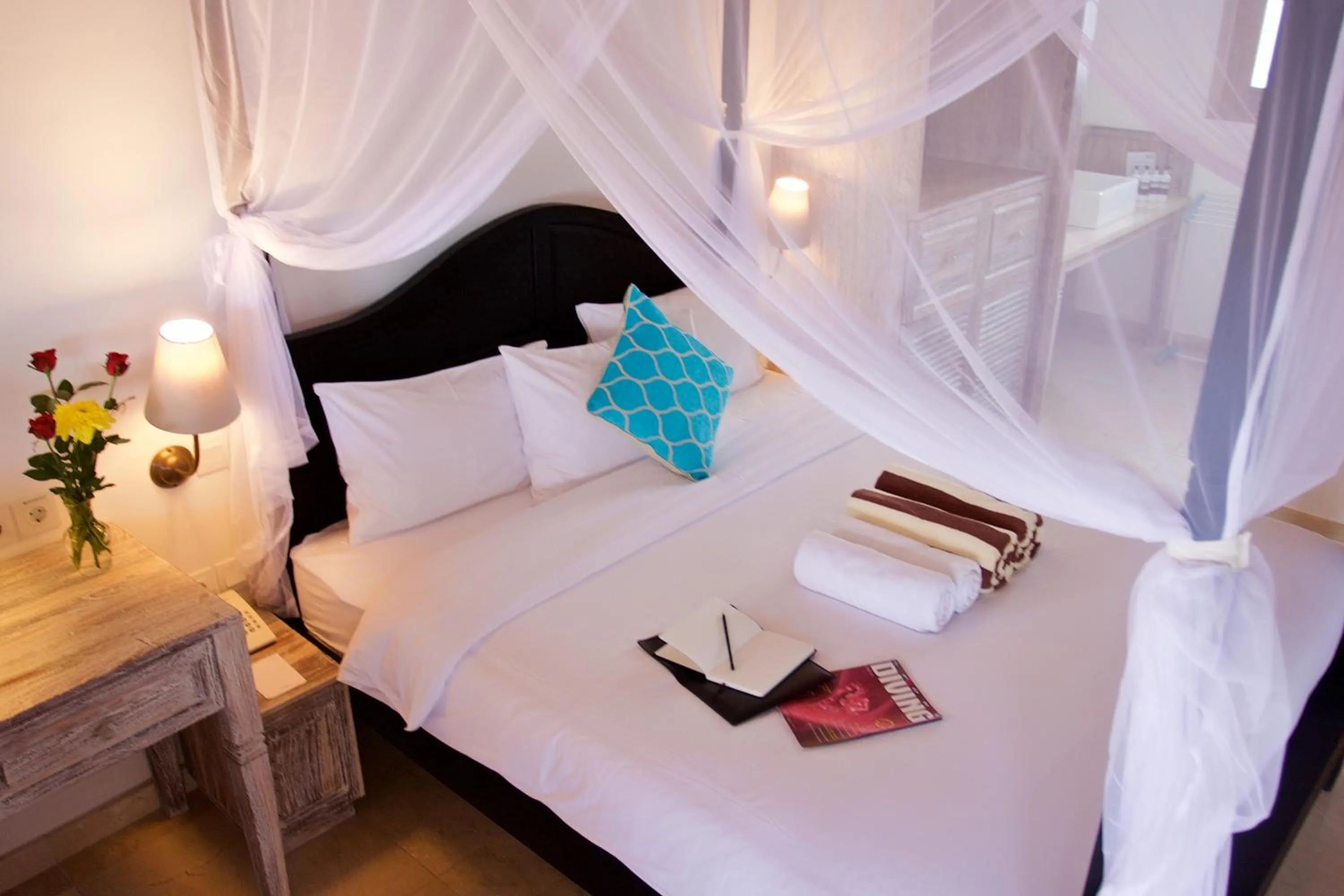 Bed in OK Divers Resort & Spa