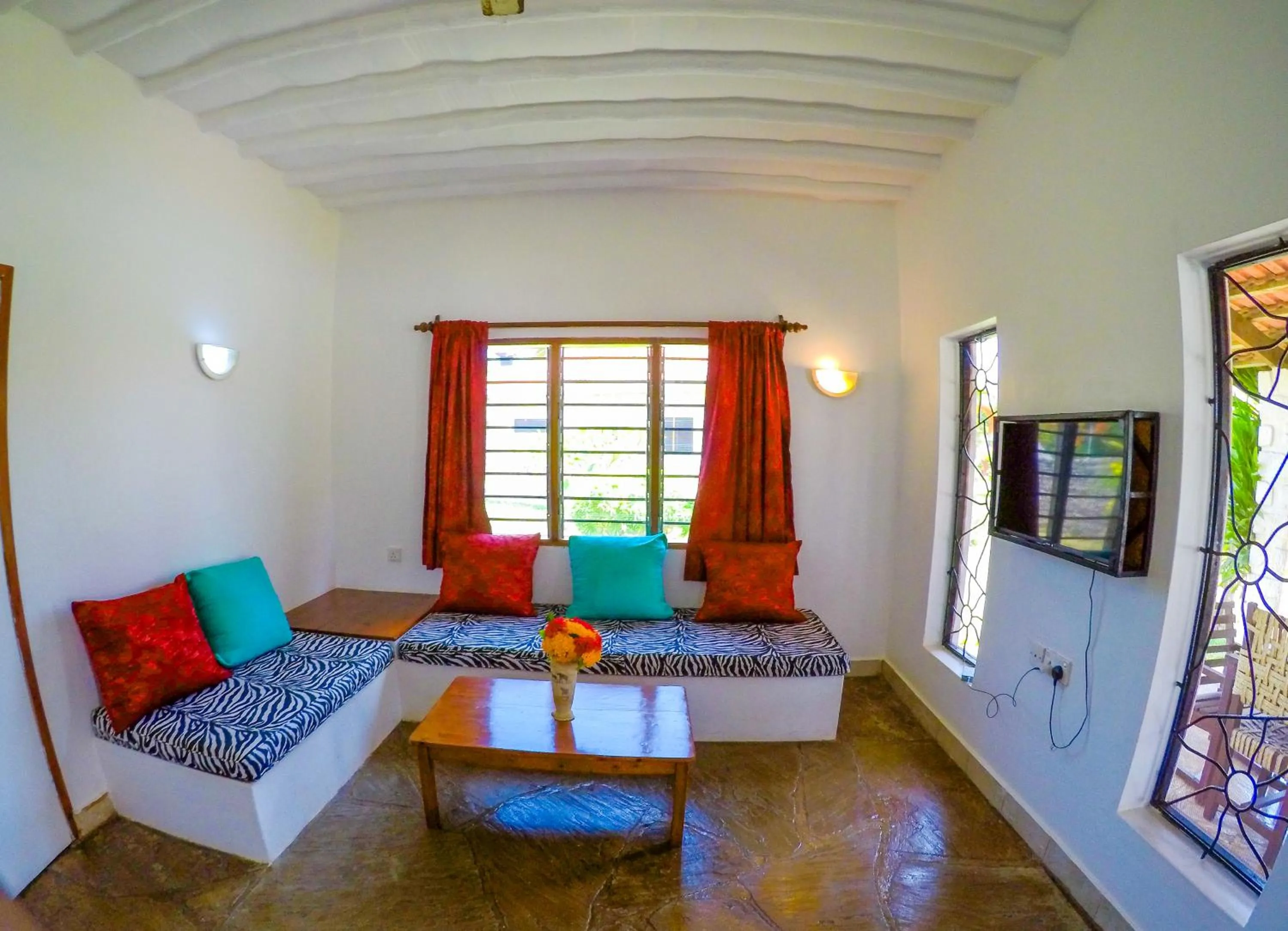 Communal lounge/ TV room in Doric Cottages Diani