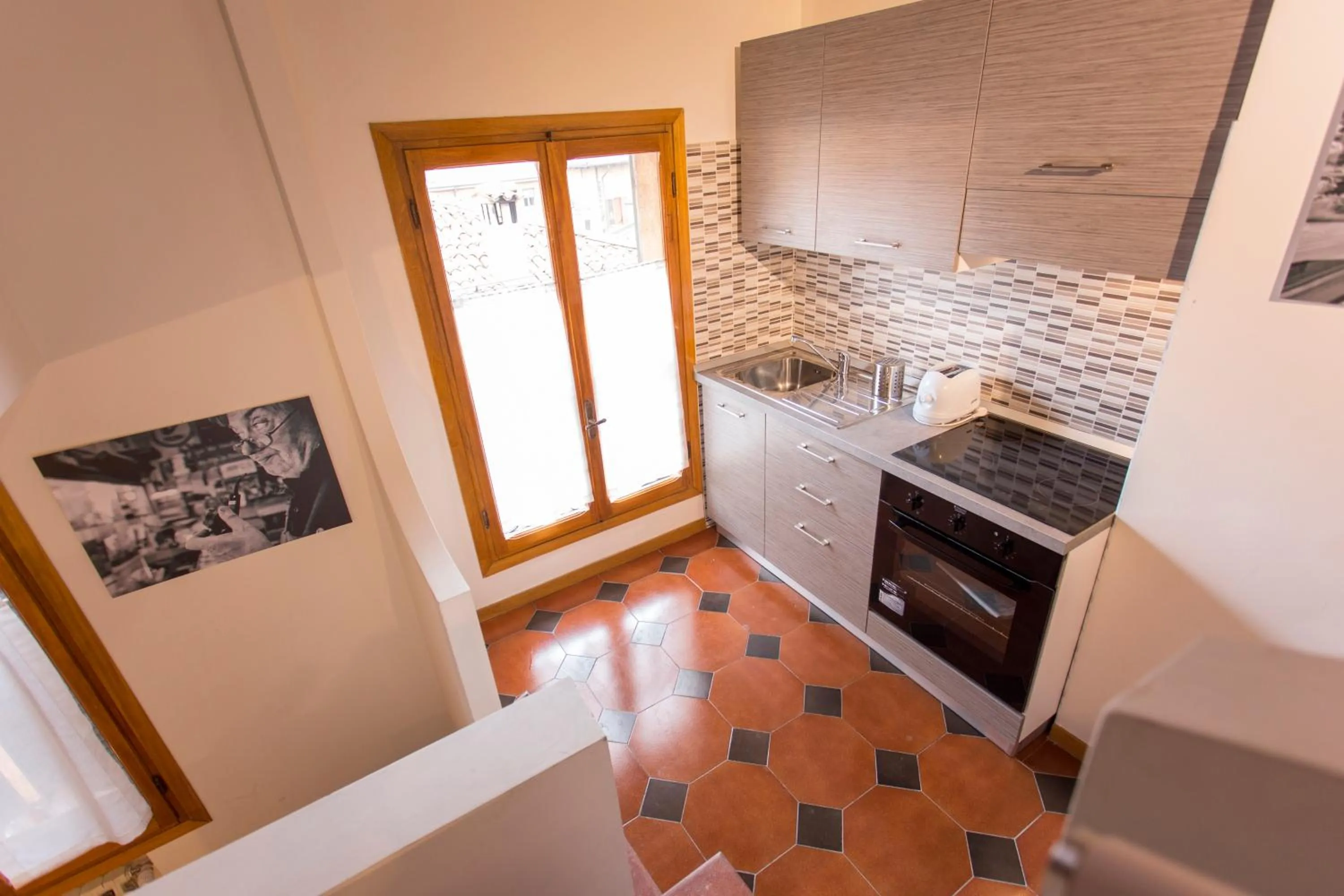 Kitchen or kitchenette in Residenza Ariosto Depandance by Studio Vita