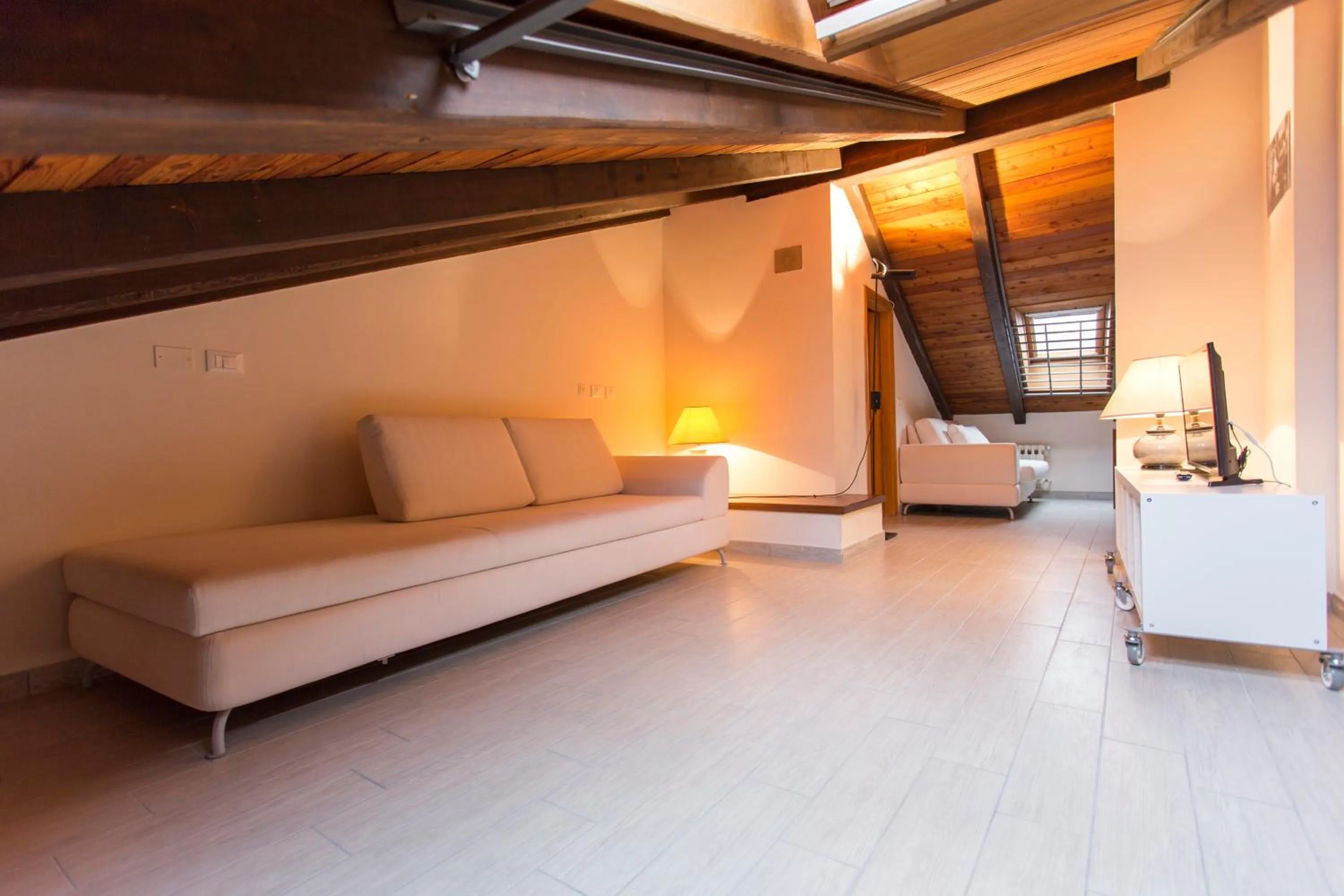 Living room, Bed in Residenza Ariosto Depandance by Studio Vita