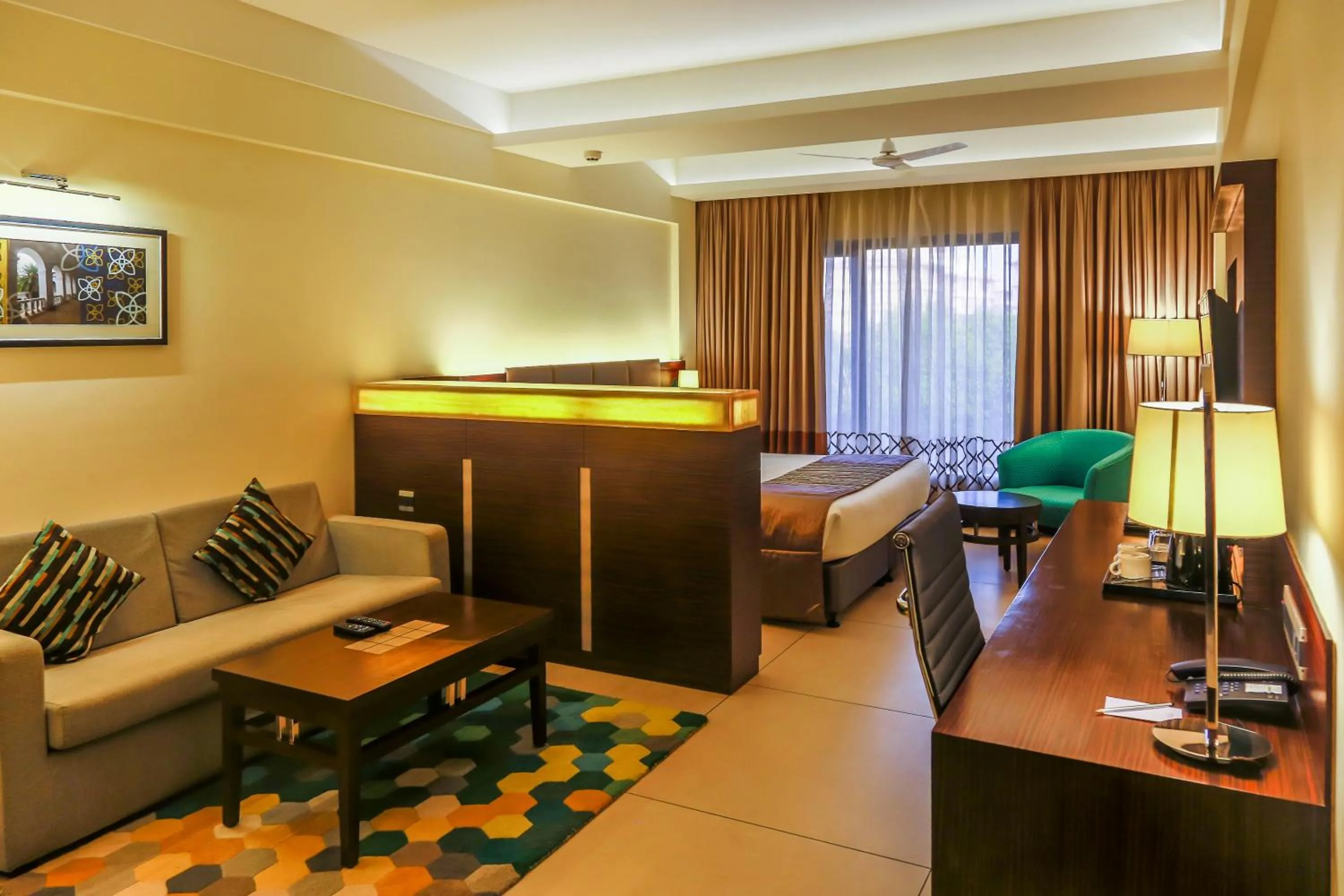 Seating area, Bed in The Fern Kadamba Hotel And Spa