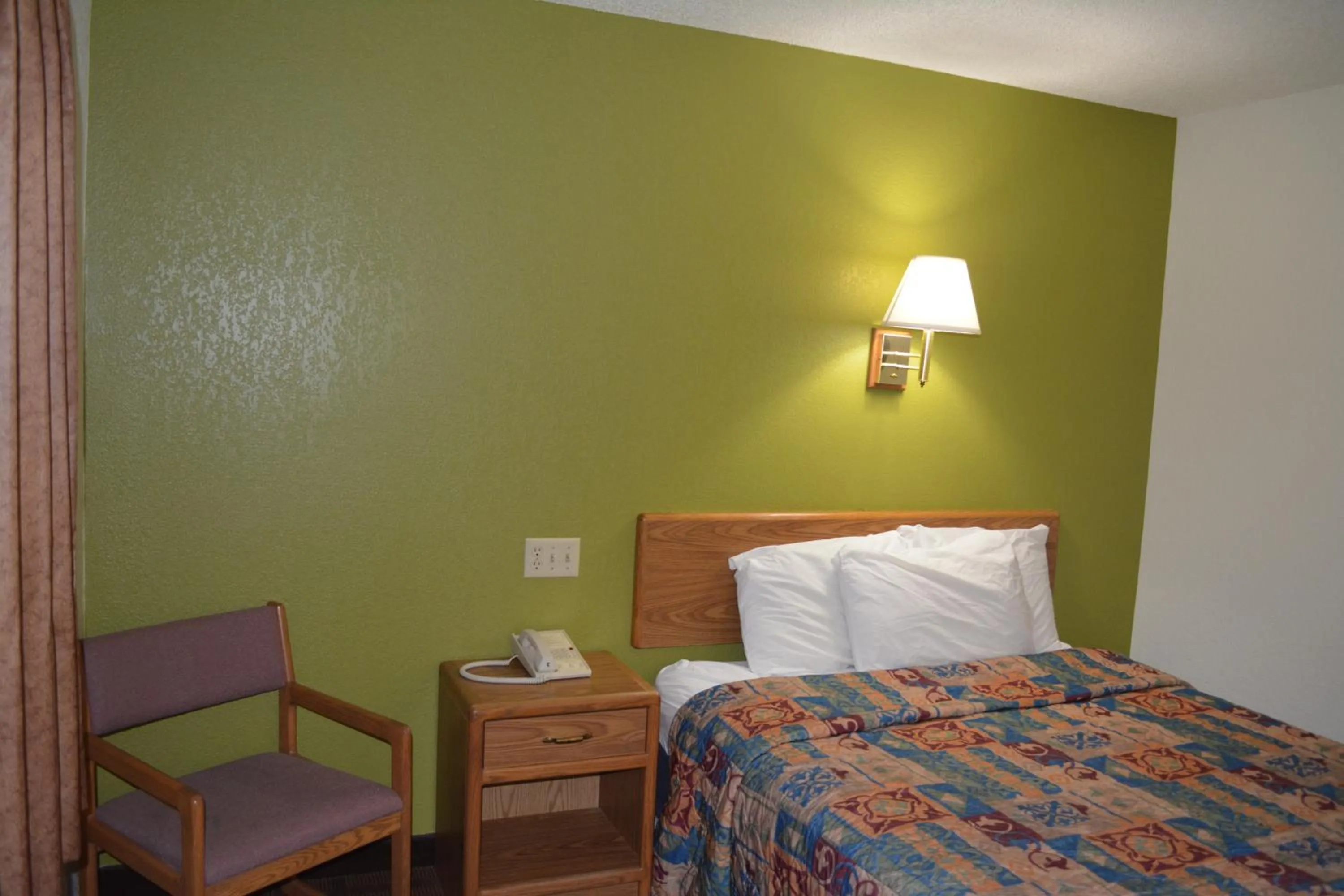 Bed in Bloomer Inn & Suites