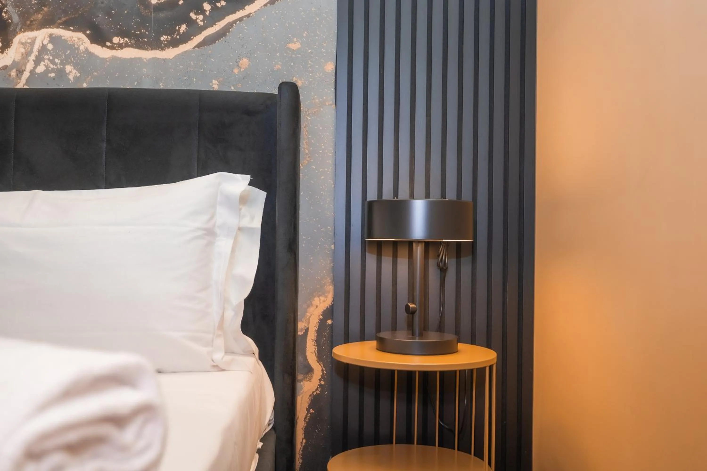 Bed in Noah Gate Hotel & Suites