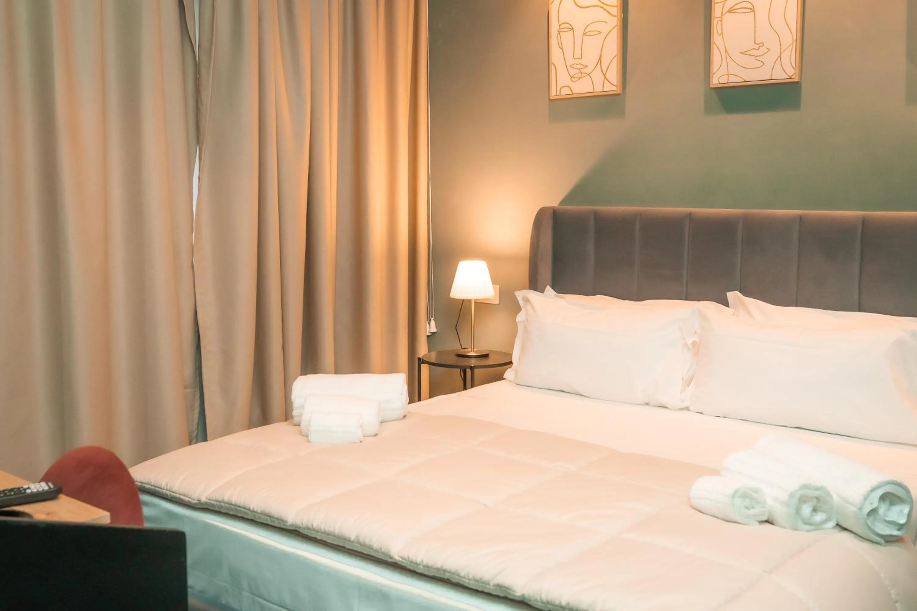 Bed in Noah Gate Hotel & Suites