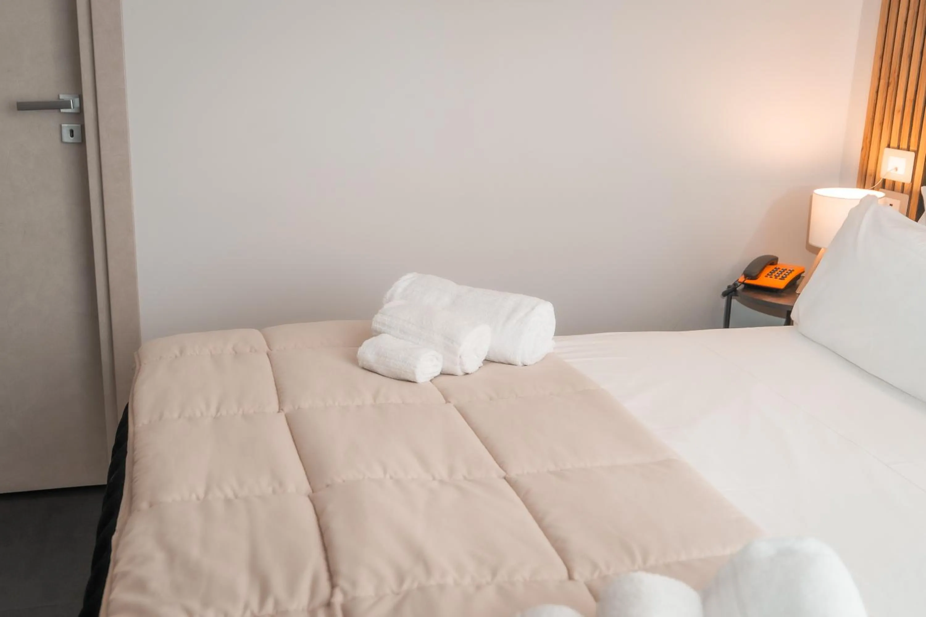 Bed in Noah Gate Hotel & Suites