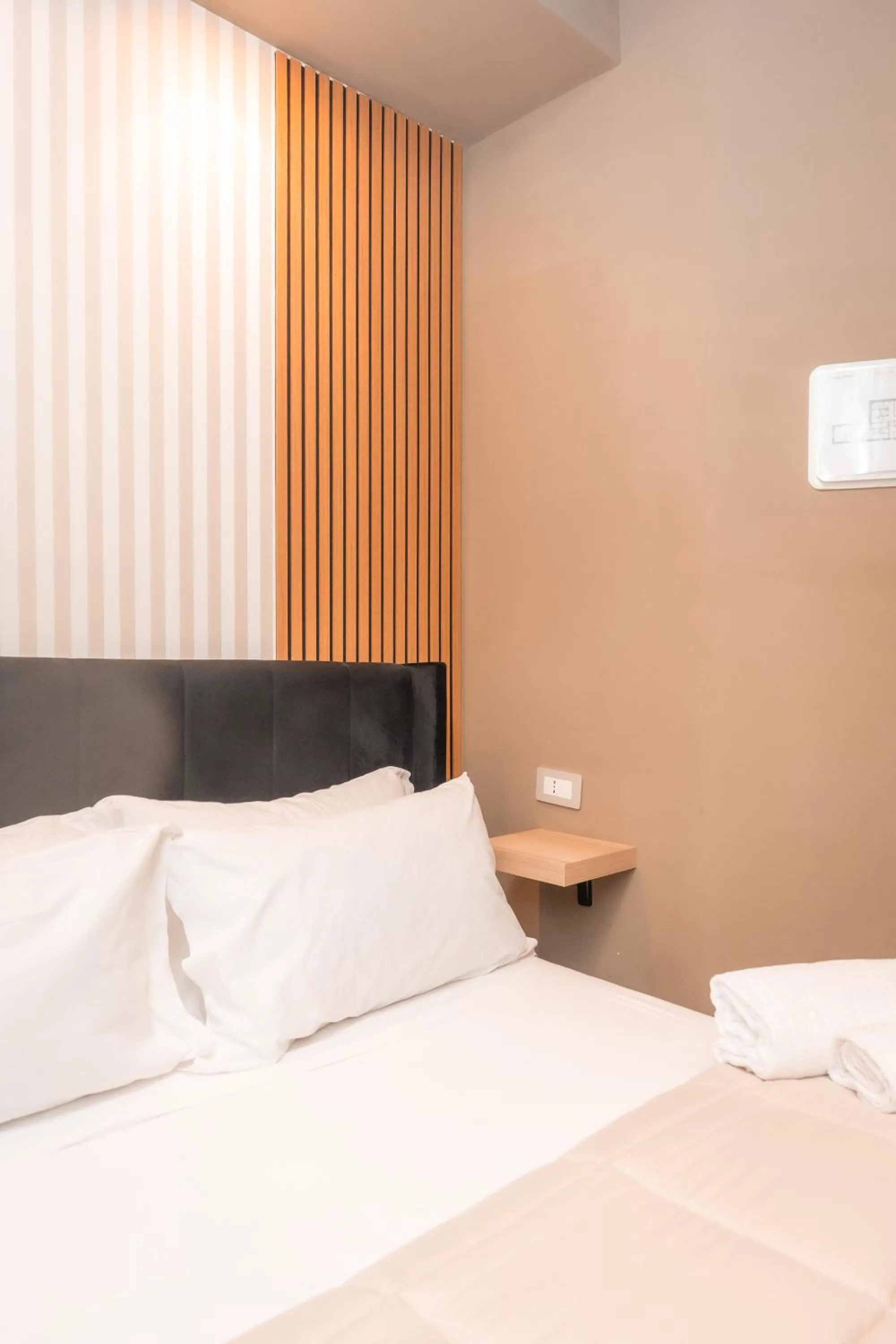 Bed in Noah Gate Hotel & Suites
