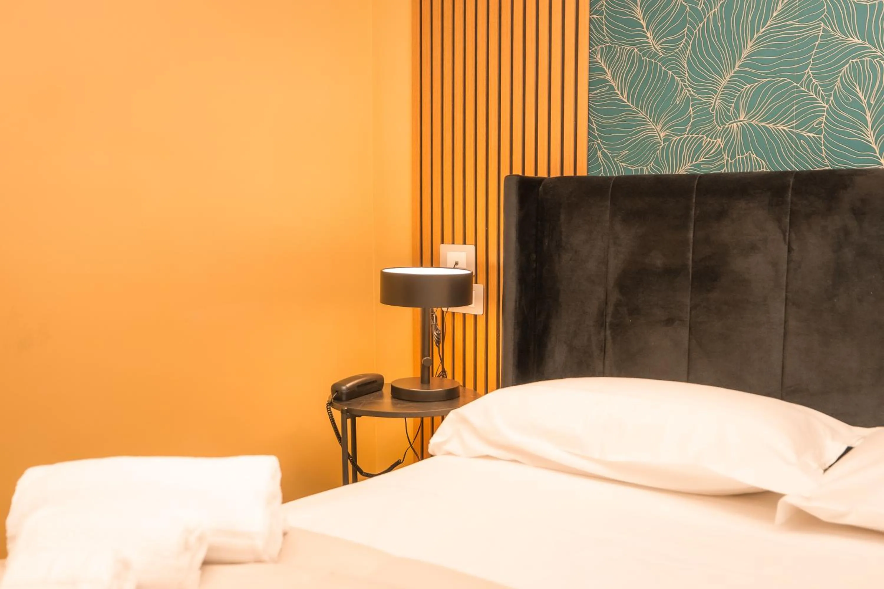 Bed in Noah Gate Hotel & Suites