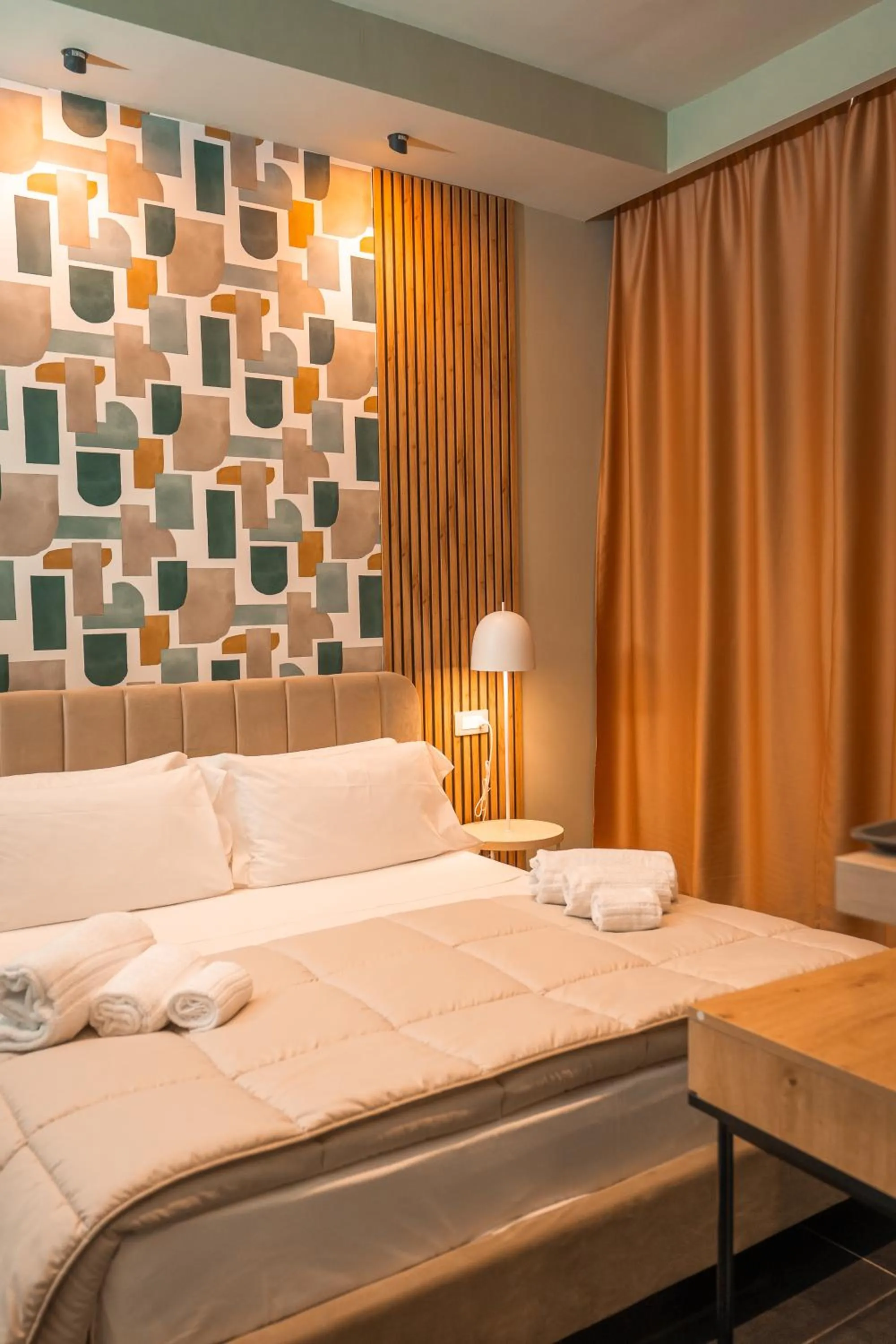 Bed in Noah Gate Hotel & Suites