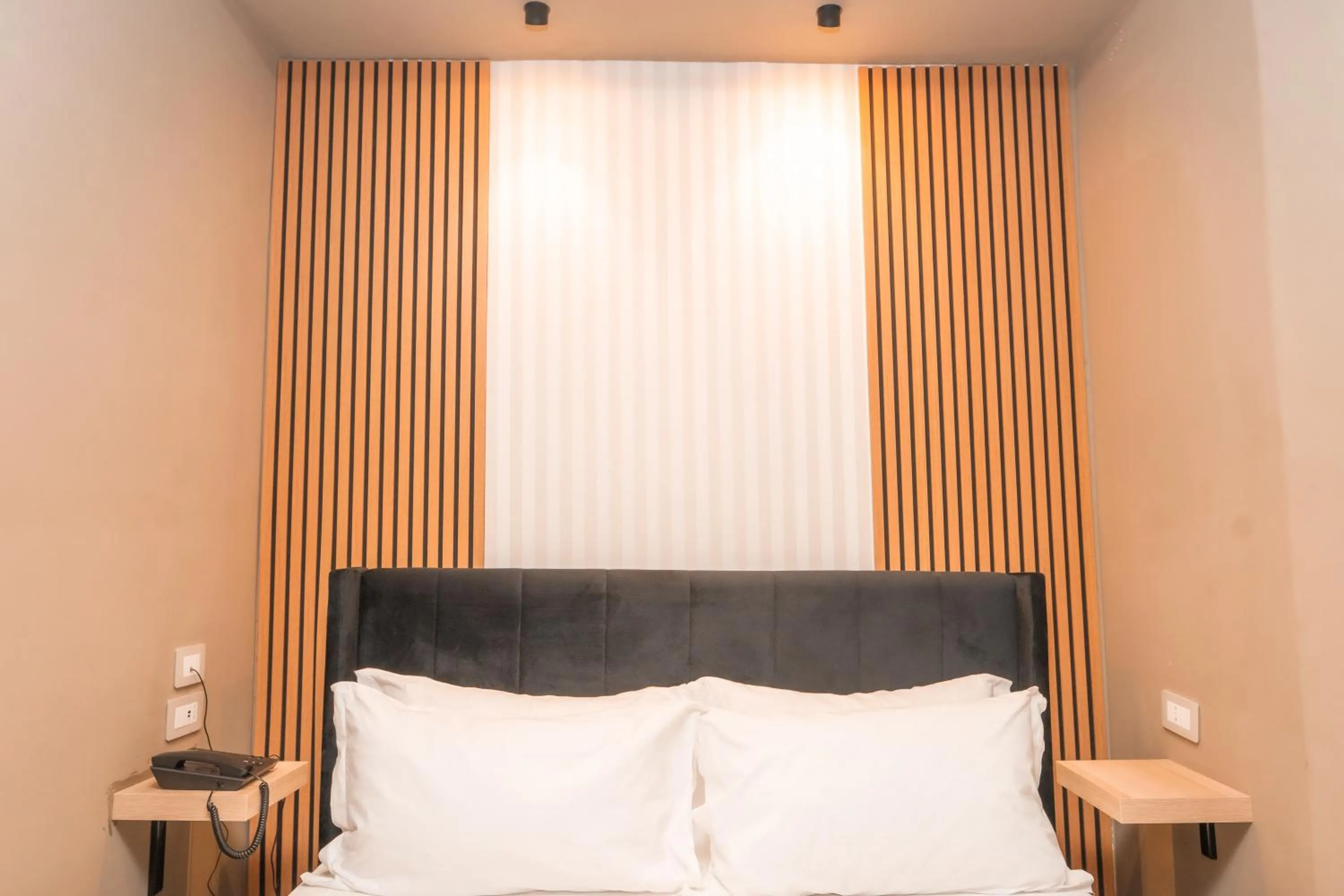 Bed in Noah Gate Hotel & Suites
