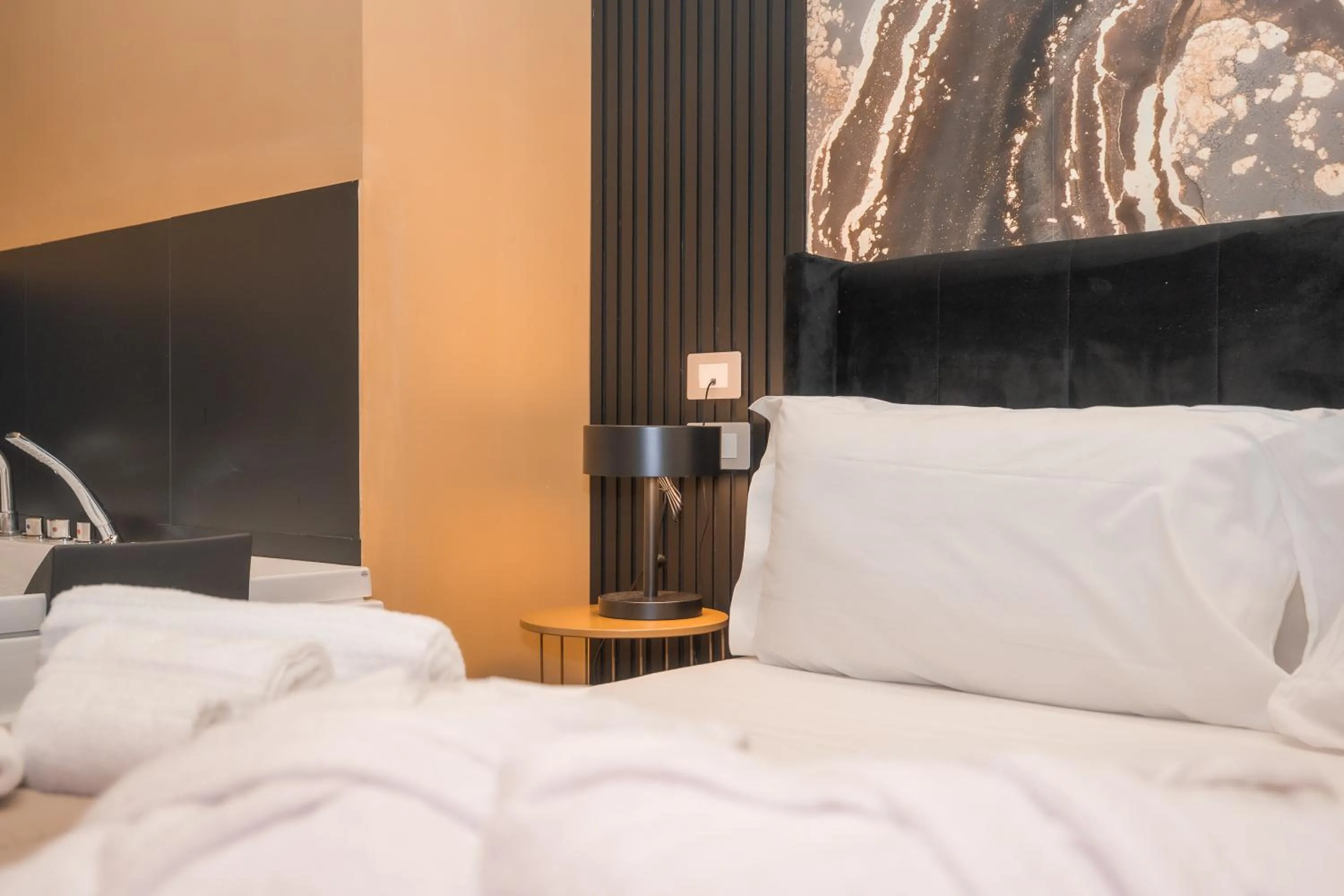 Bed in Noah Gate Hotel & Suites