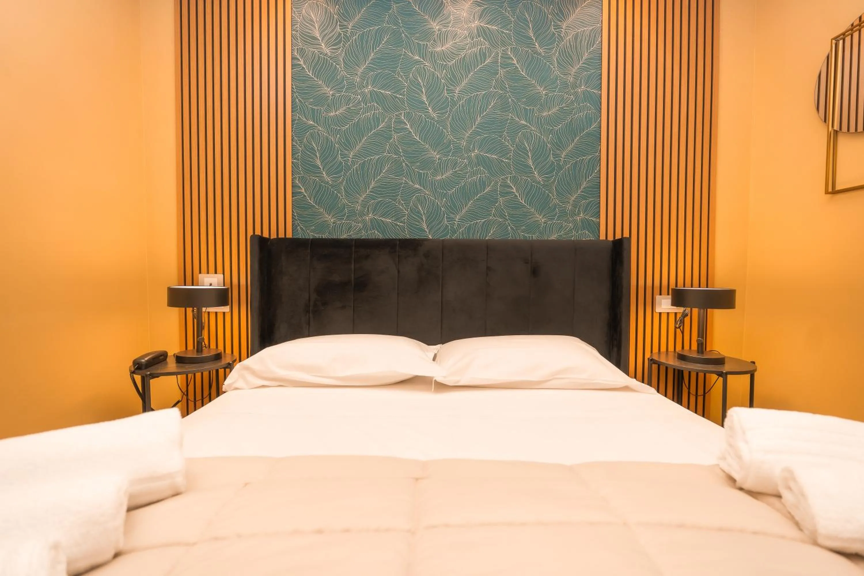 Bed in Noah Gate Hotel & Suites