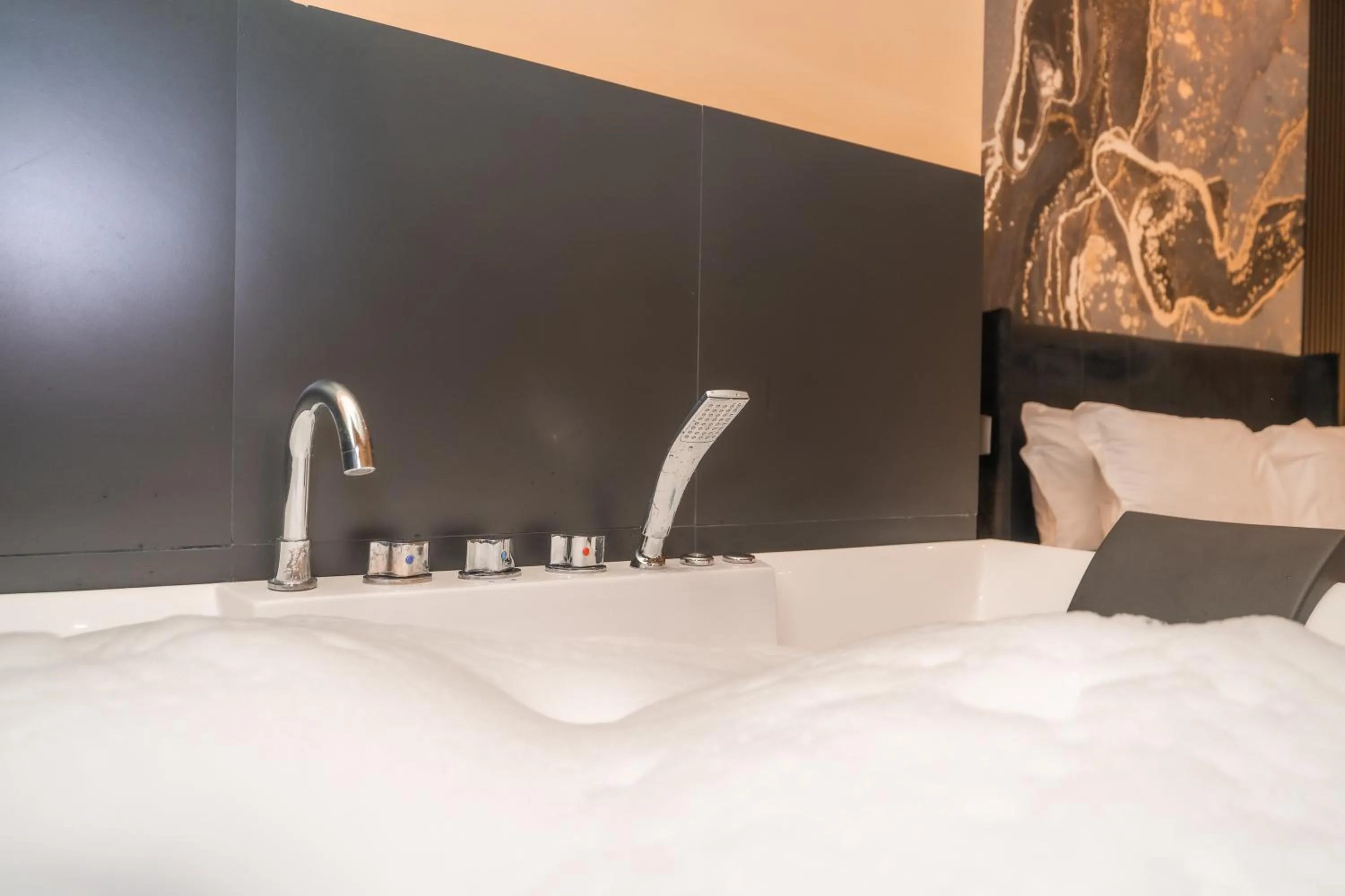 Bed in Noah Gate Hotel & Suites