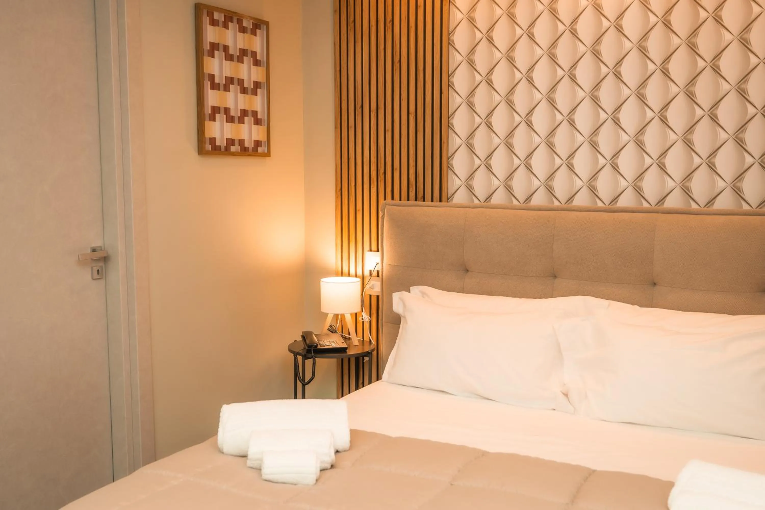 Bed in Noah Gate Hotel & Suites