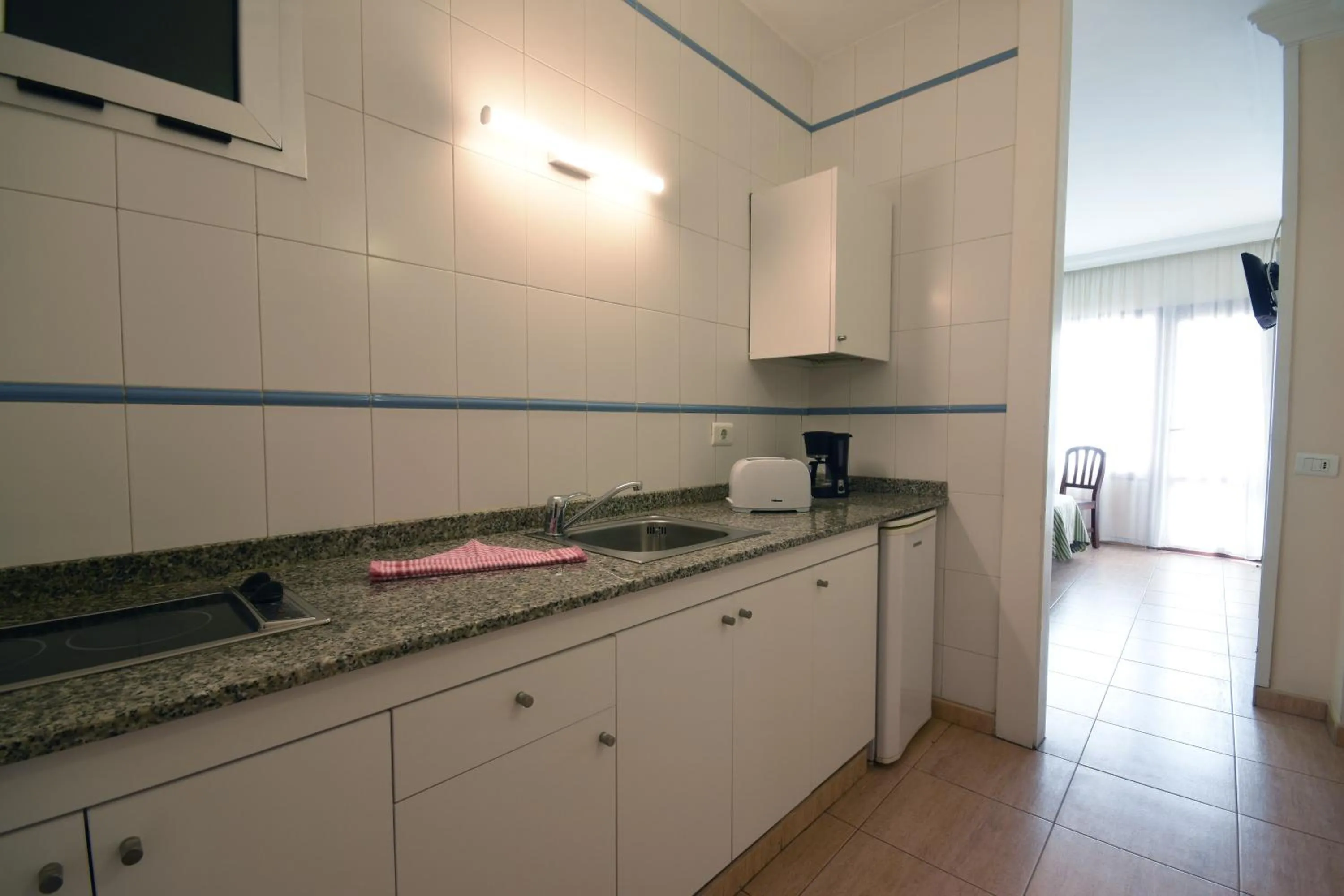 Kitchen or kitchenette in Apartamentos Tinoca