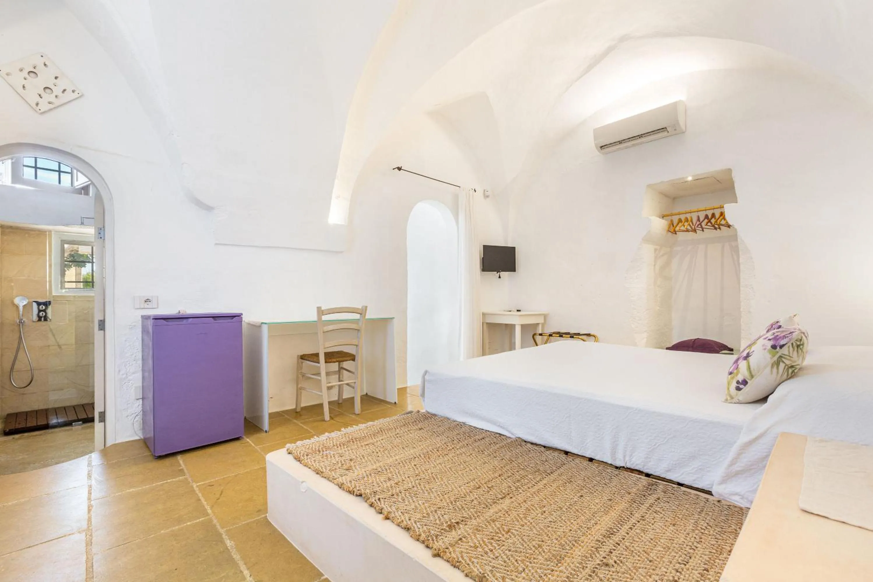 Bed in Masseria Li Capperi by Perle di Puglia