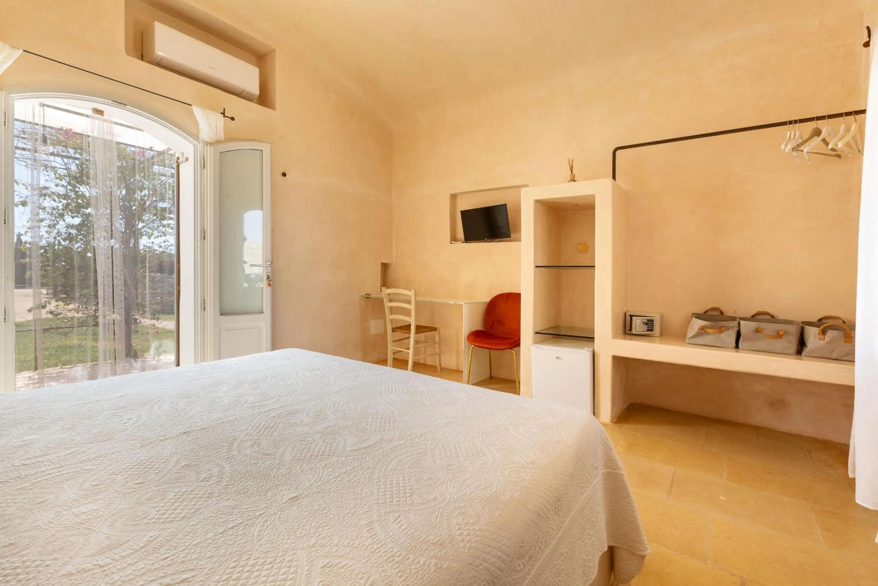 Bed in Masseria Li Capperi by Perle di Puglia