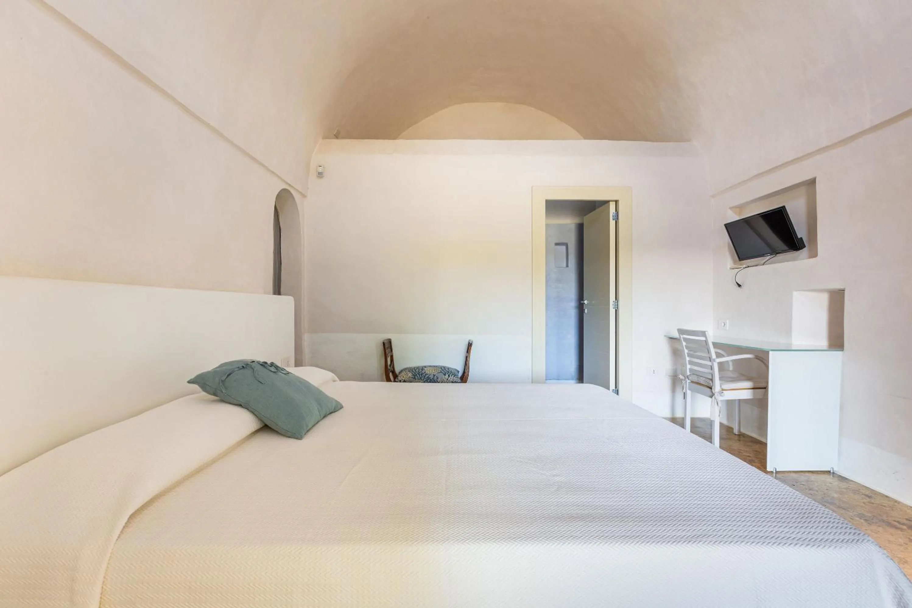 Bed in Masseria Li Capperi by Perle di Puglia
