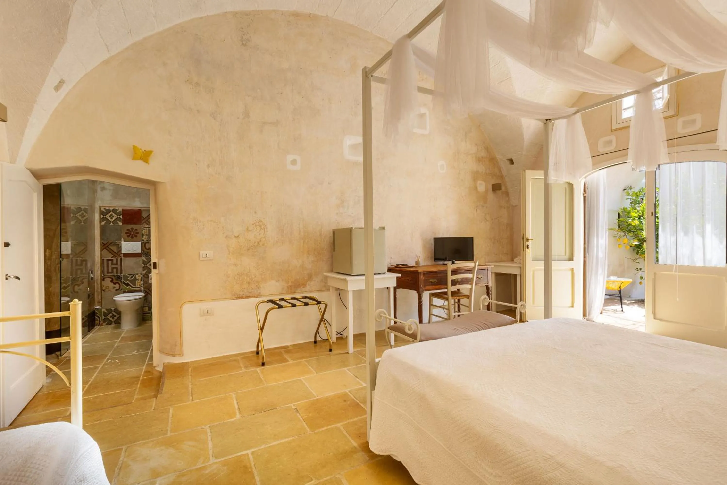 Bed in Masseria Li Capperi by Perle di Puglia