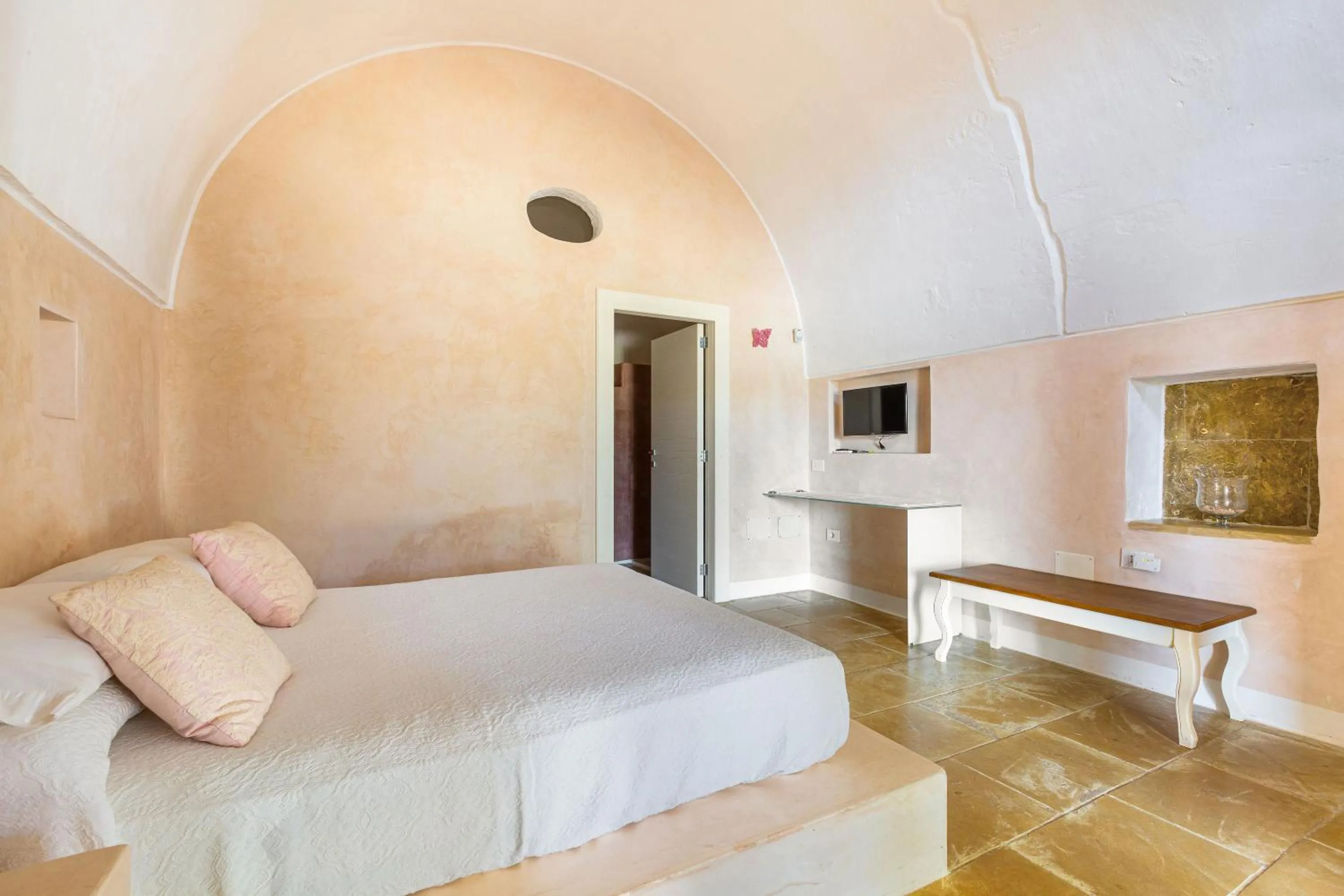 Bed in Masseria Li Capperi by Perle di Puglia