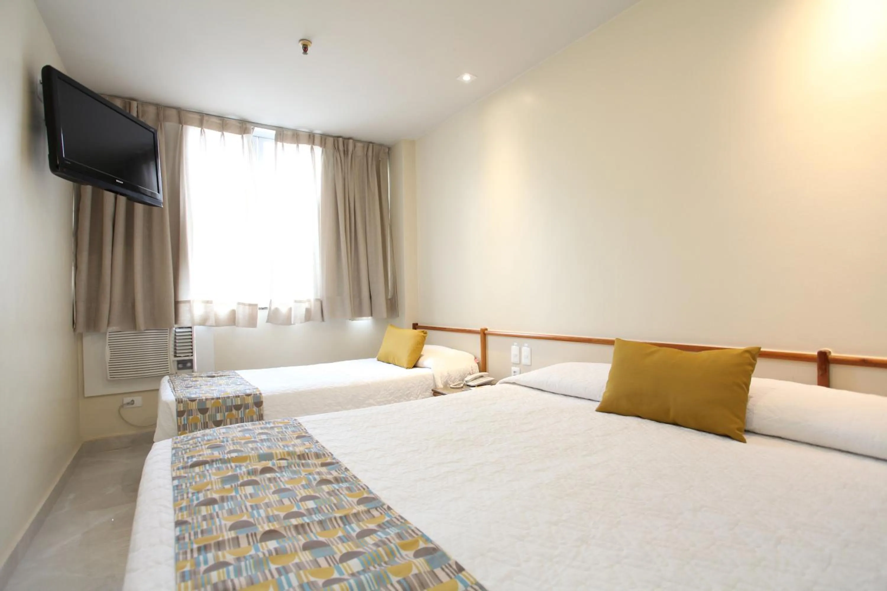 Communal lounge/ TV room, Bed in Mengo Palace Hotel