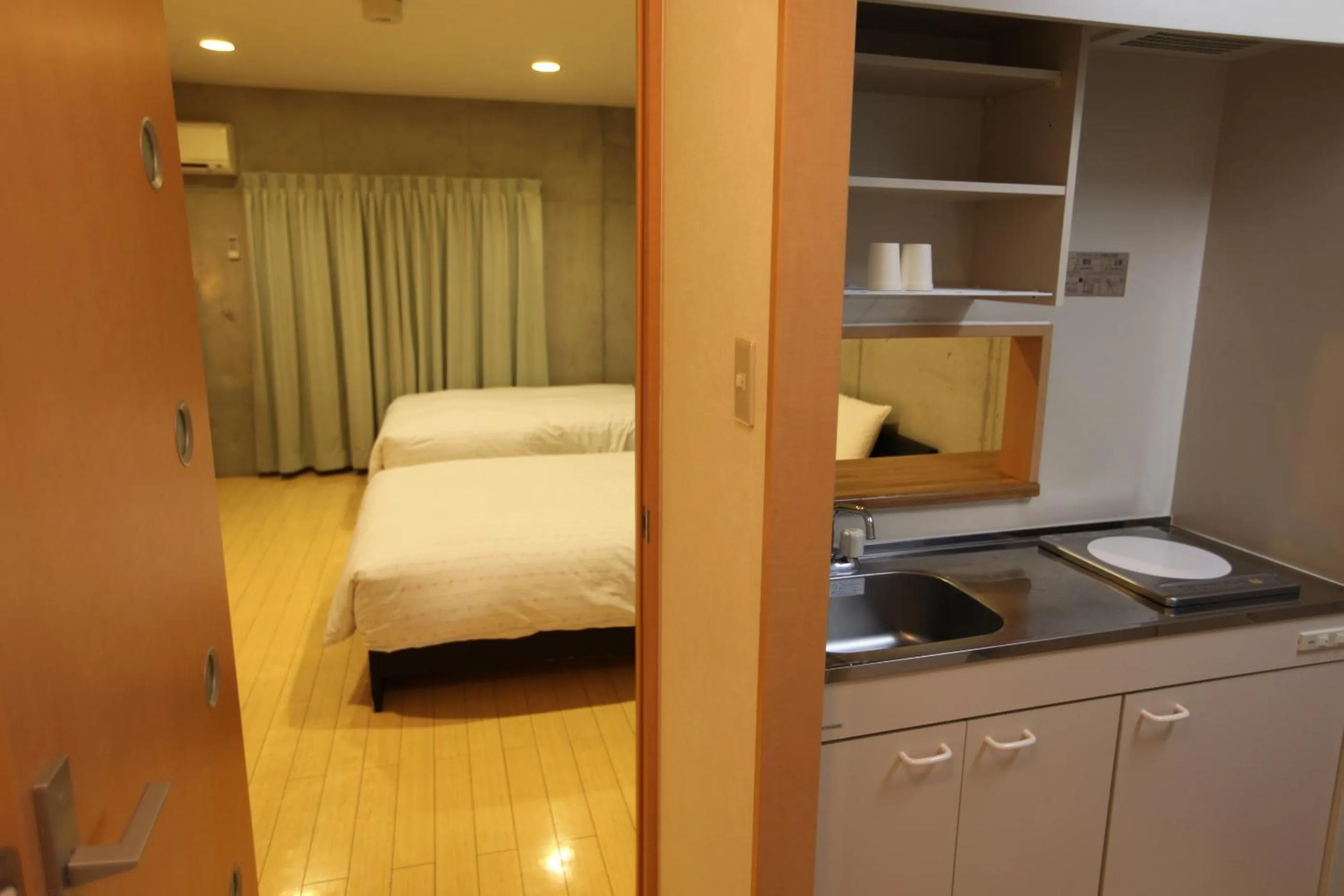 Kitchen or kitchenette, Bed in NAHA-WEST INN