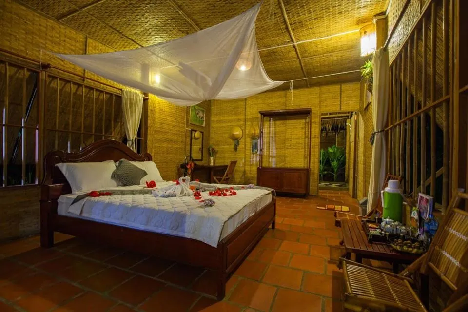 Bed in Mekong Ecolodge Bungalow