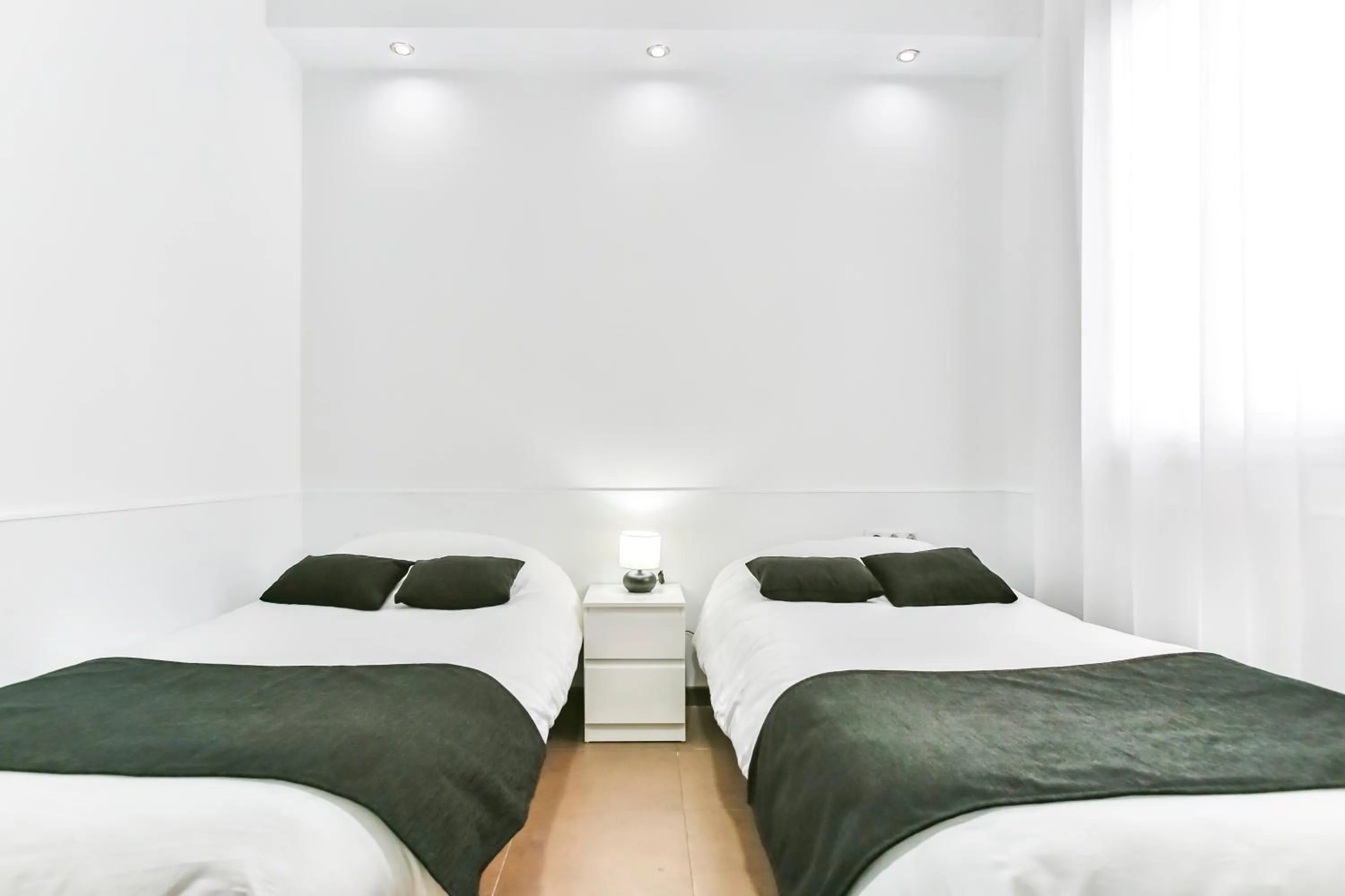 Bed in Laramond Barcelona Rooms